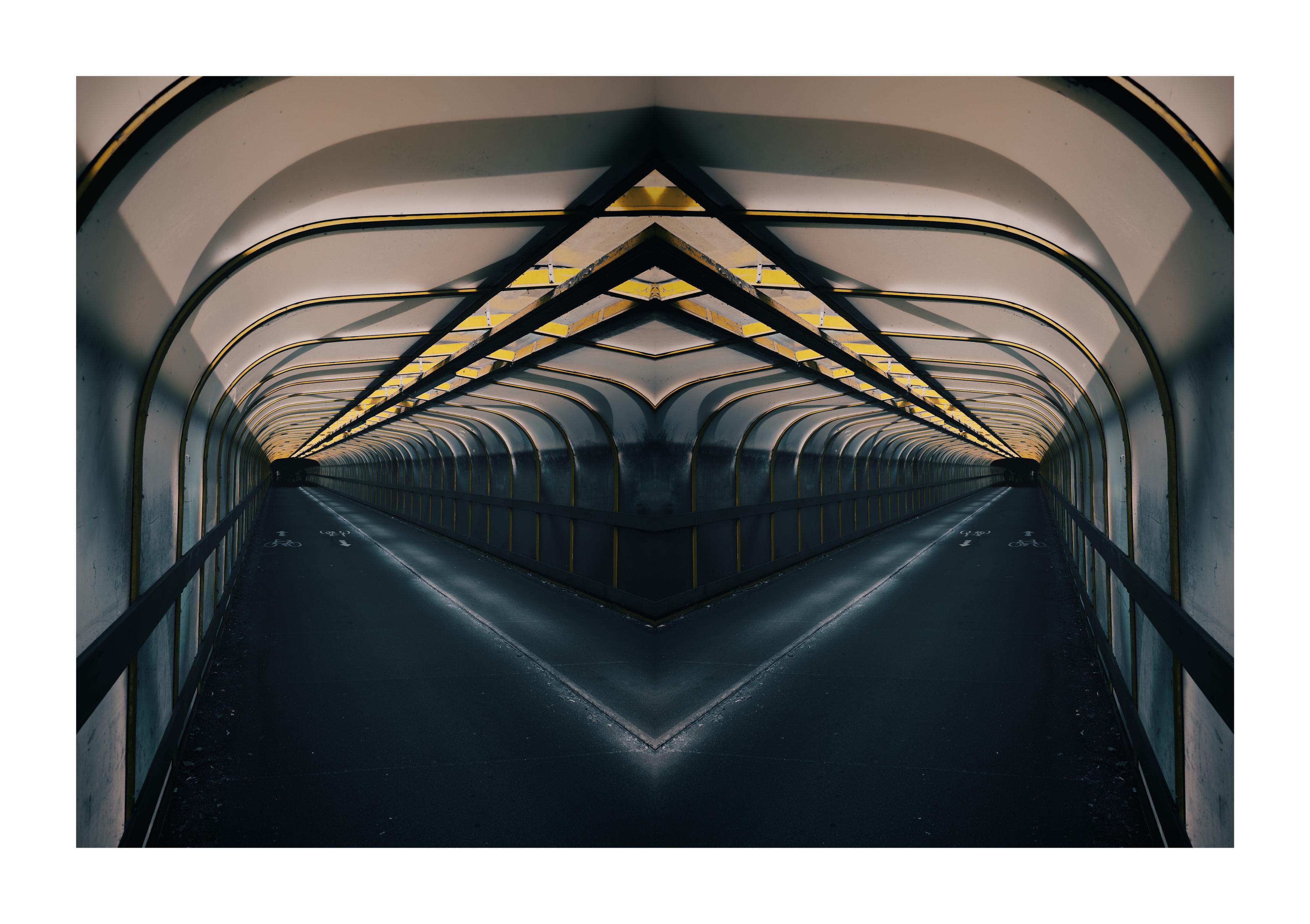 A symmetrical shot of a walkway tunnel leading in two directions.