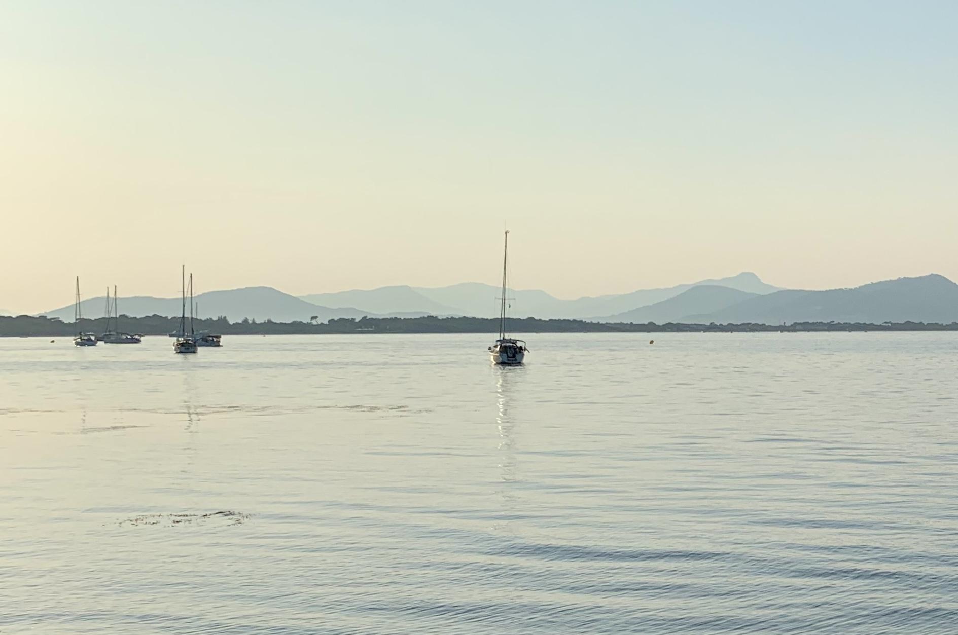 Shades of blue in the Bay of Hyères (Giens Peninsula) with a few moored boats.
