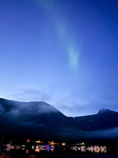 The harbor and mountains with a whisp of aurora