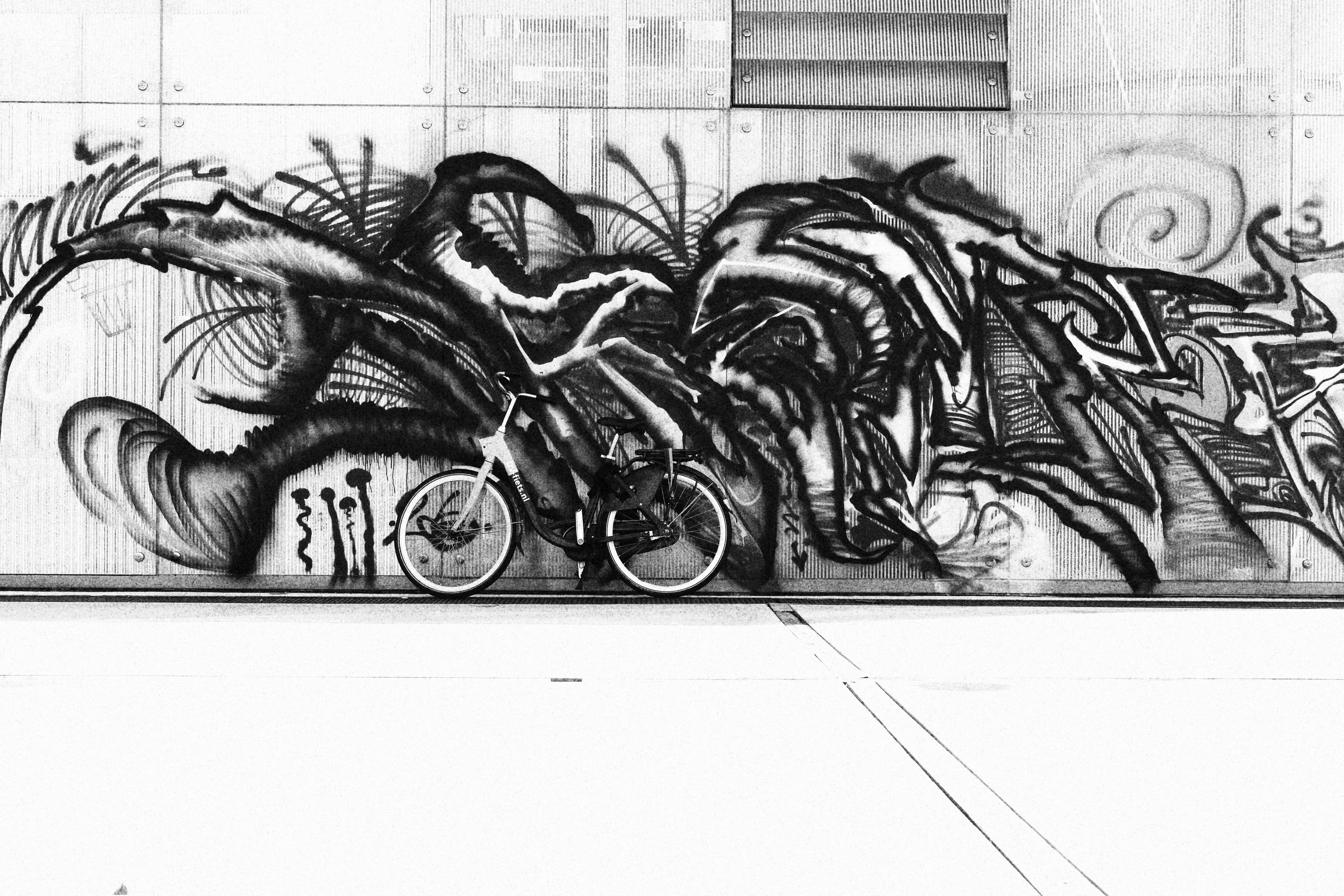A bicycle standing in front of graffiti. Rotterdam 20-8-2026