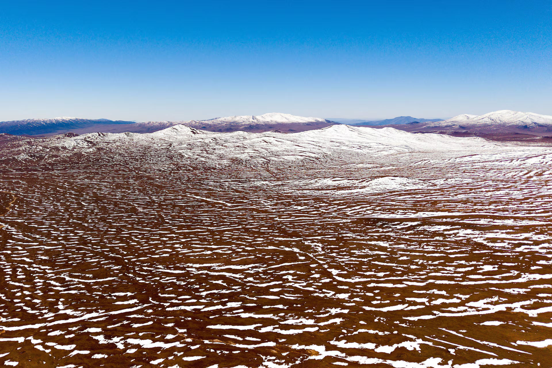 A drone view shows snow covering Atacama desert.