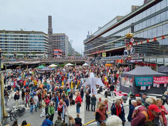 View over Sergelstorg in central Stockholm. It is packed with people activating for society to stop disrupting the Earth's climate, which we are all dependent on.