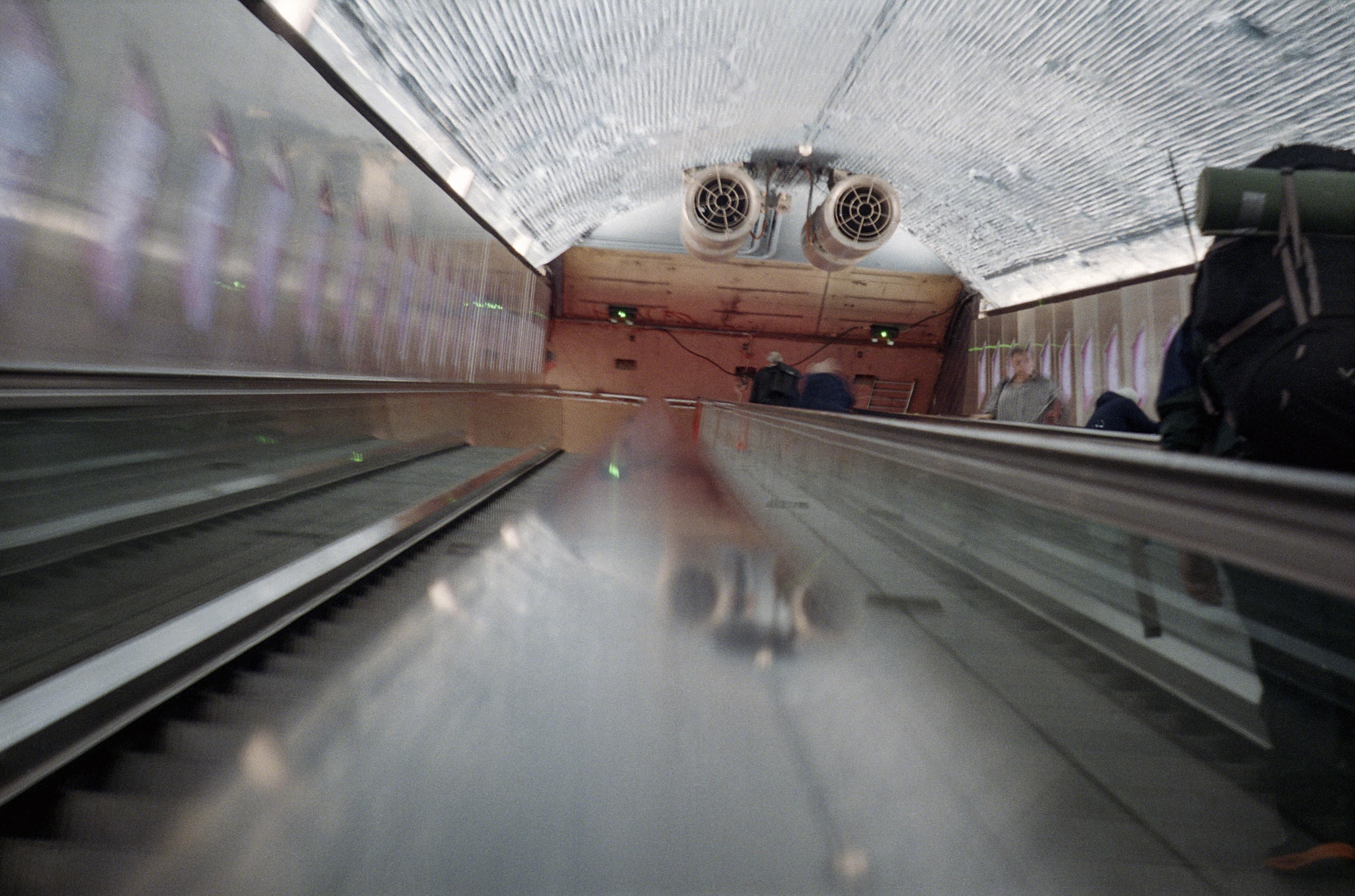 View going up a long escalator. Motion blur caused by long shutter speed.