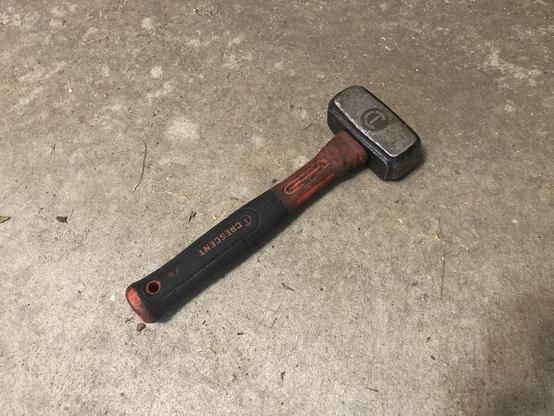 A hammer that was found lying on the pavement.