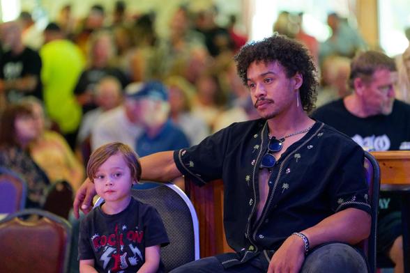 Man and boy in crowd at rock n' roll show