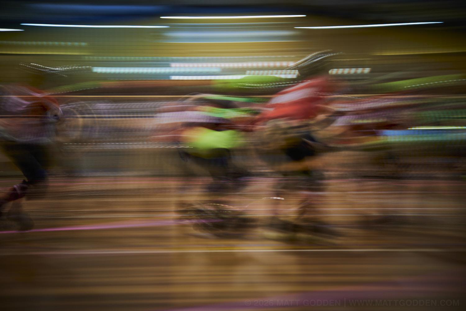 A long exposure image of roller derby competitors from the D'Viants (lime green), and the Screaming Assault Sirens (red). 2013/11/09