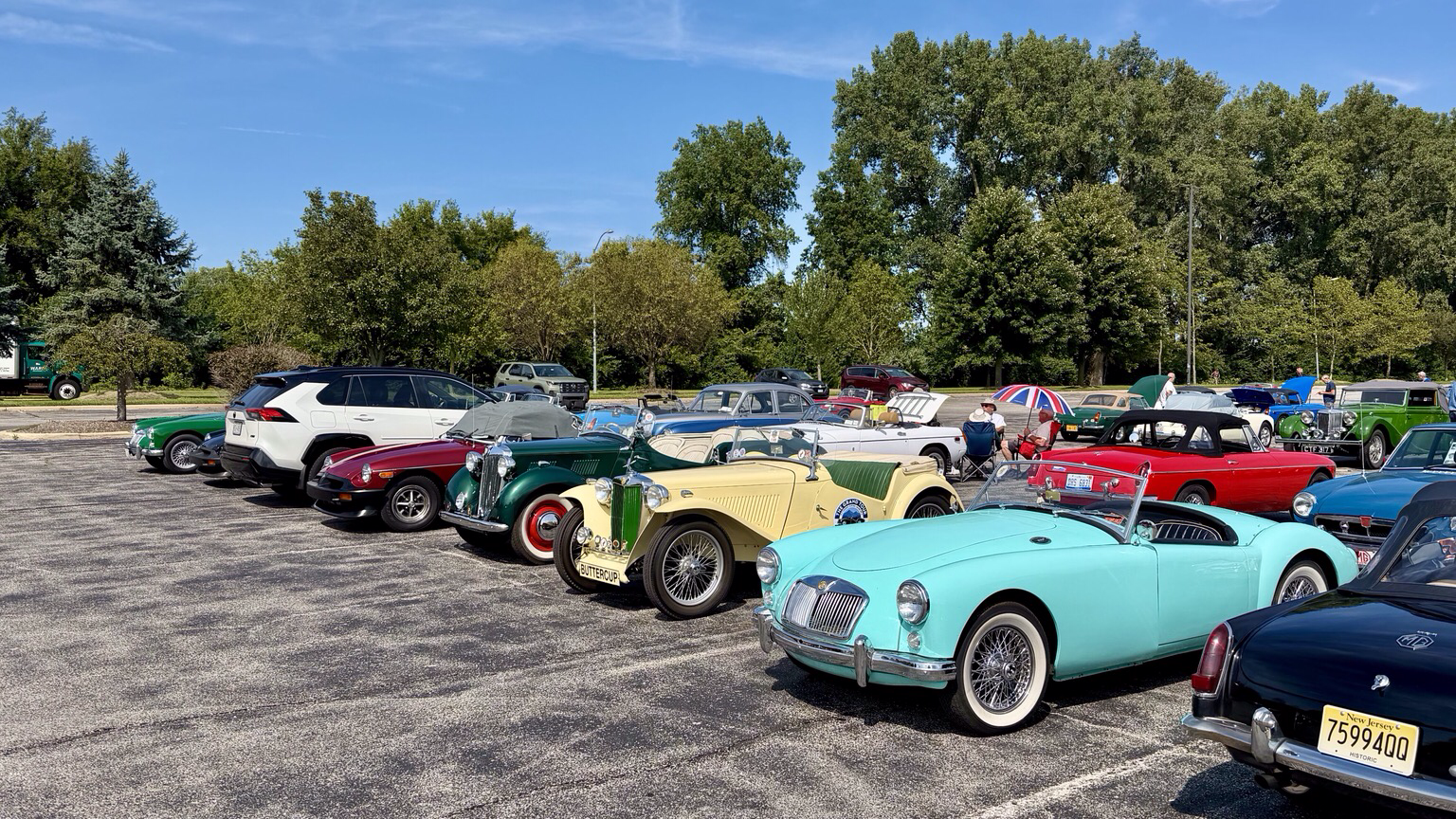 Photograph of a parking lot filled with brightly colored MG sports cars at MG International 2026 in Sandusky Ohio.
