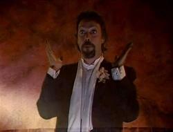 Tim Curry in the same outfit from the Lexx episode “Super Nova”
He’s gesturing with his hands to the side saying “boom”