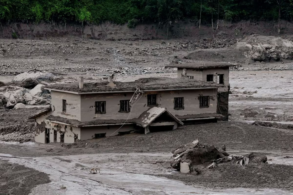 A building swept away by a river.