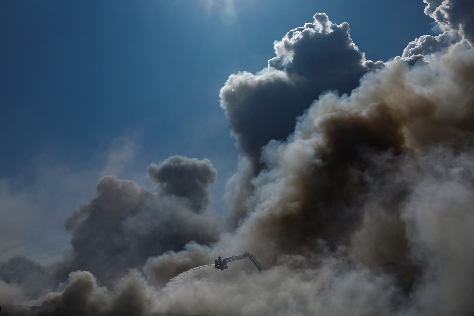 A firefighterA firefighter works to extinguish a fire as smoke rises from a warehouse damaged during Russian drone strikes in Kyiv region, Ukraine, August 27. REUTERS/Valentyn Ogirenko #photography #Ukraine #firefighters