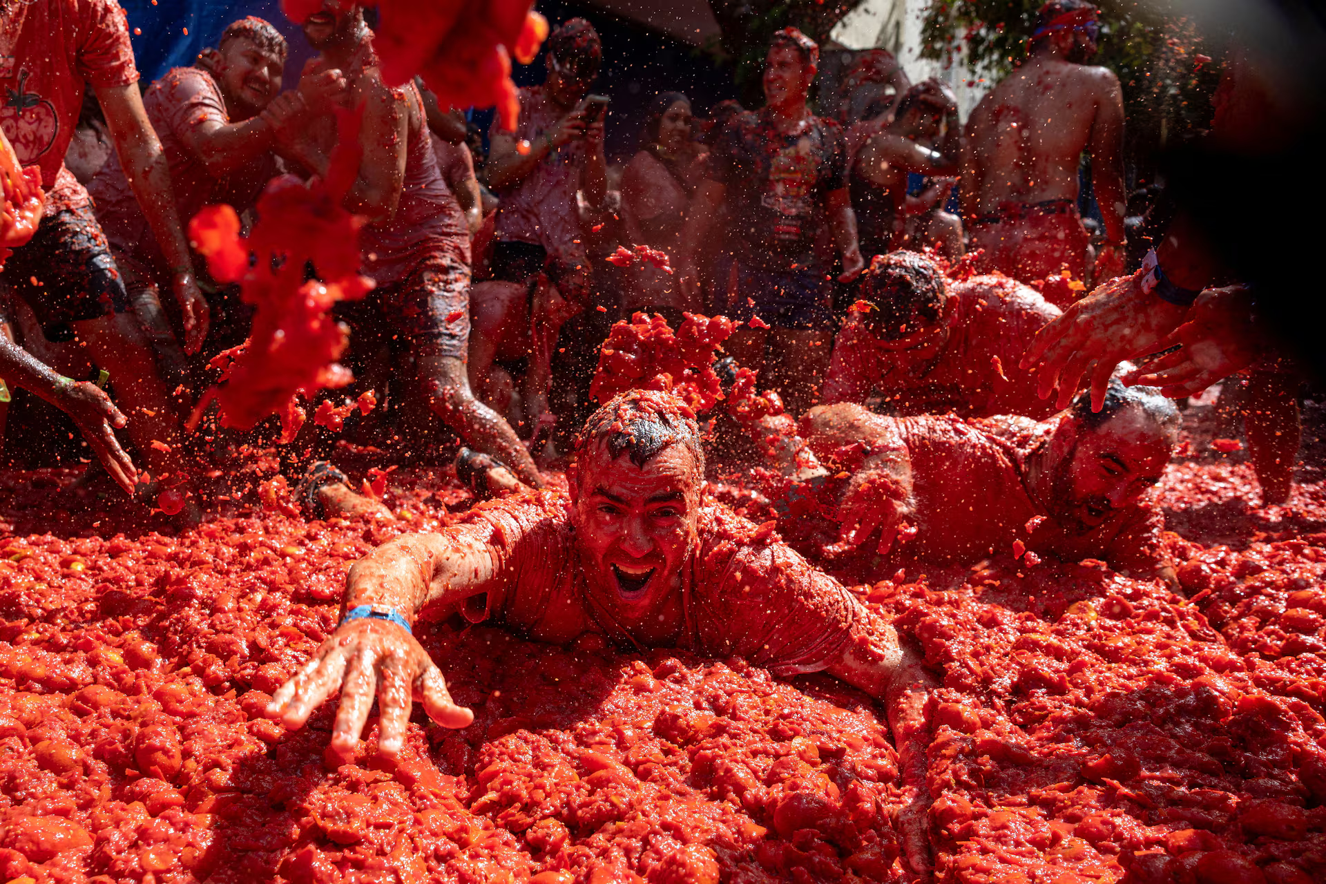 Revelers bath in tomatoes during the annual "La Tomatina" food fight festival.