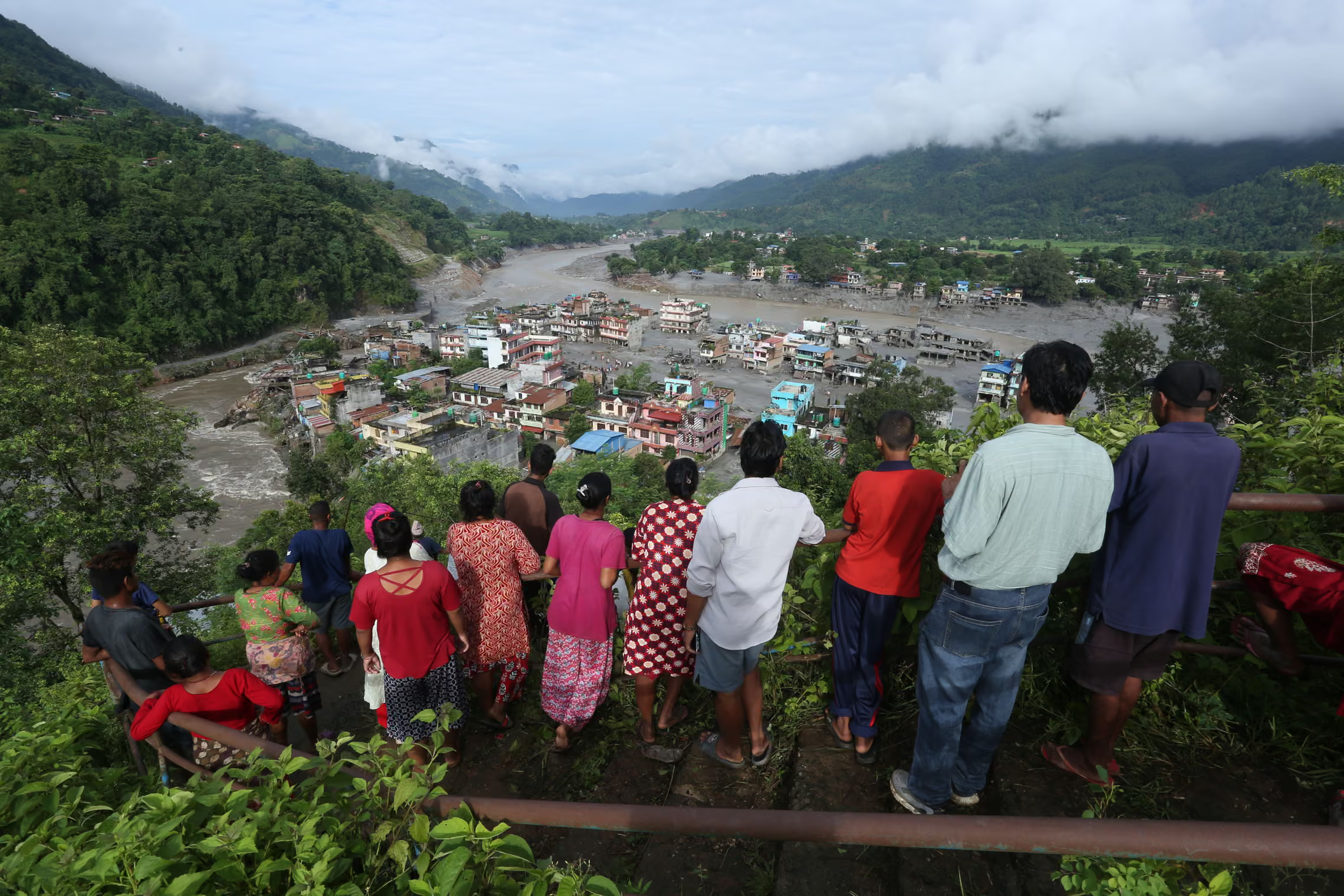 Residents look at the devastation left by flash flooding.