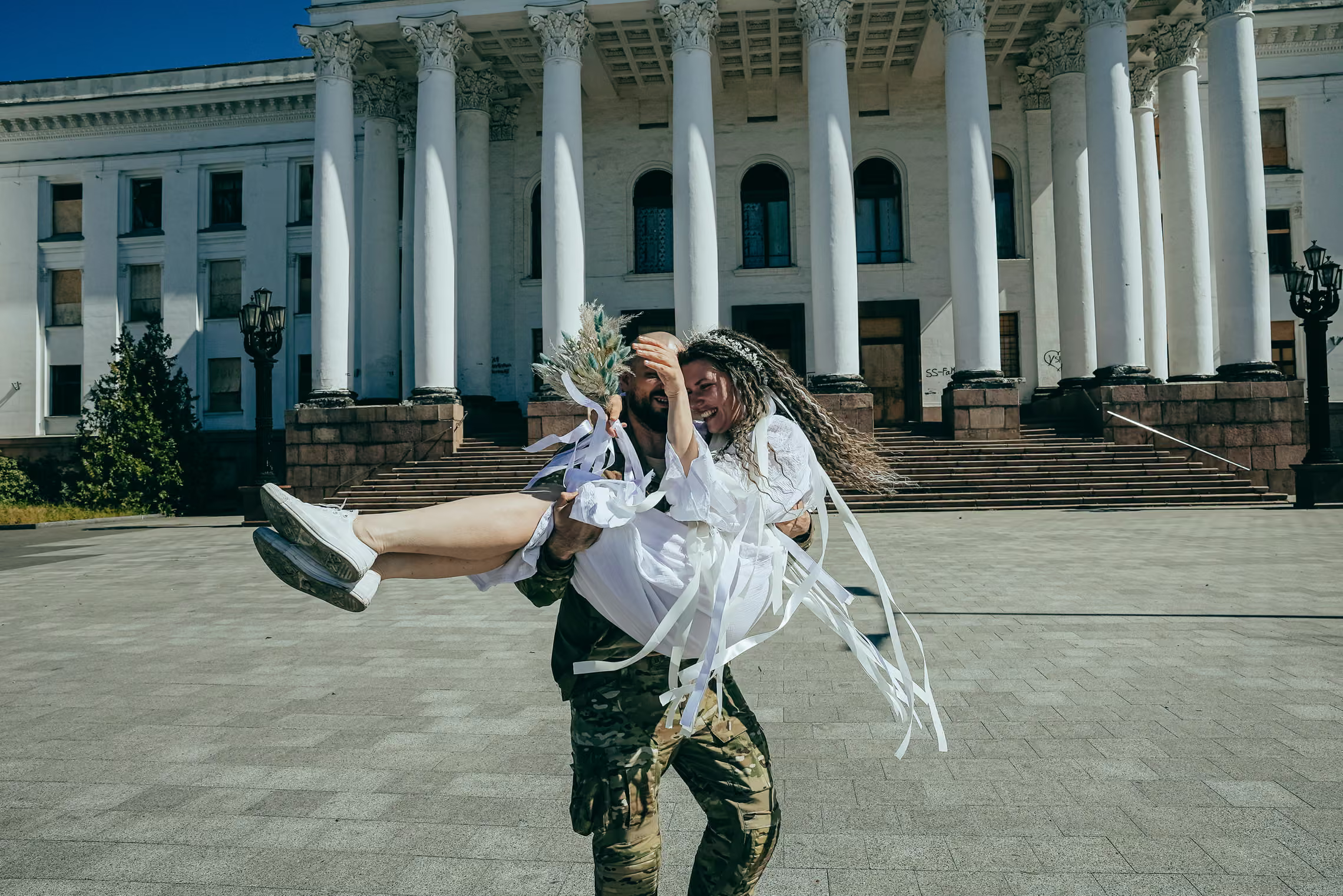 A soldier lifts his bride.