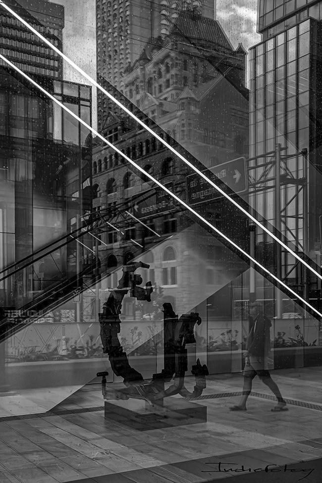 Reflections of a man and buildings from different era and architectural style