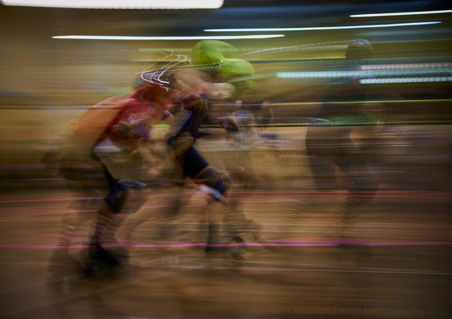 A long exposure image of roller derby competitors from the D'Viants (lime green), and the Screaming Assault Sirens (red). 2013/11/09