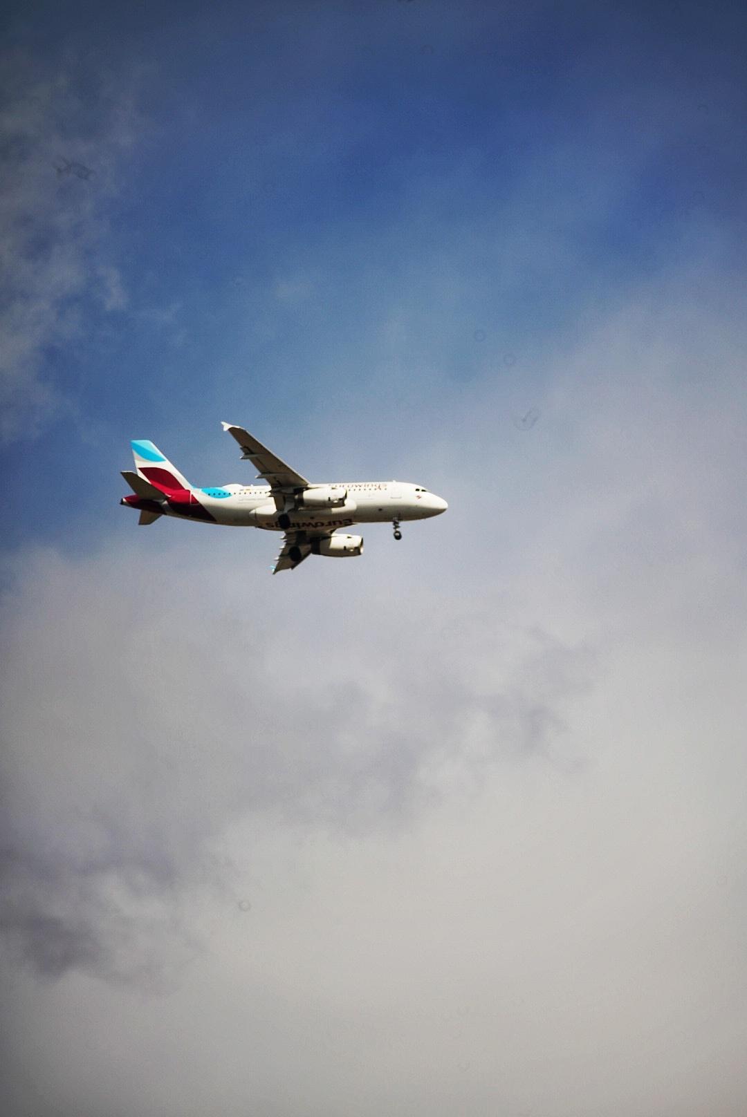 Flugzeug vor Himmel mit einigen Wolken