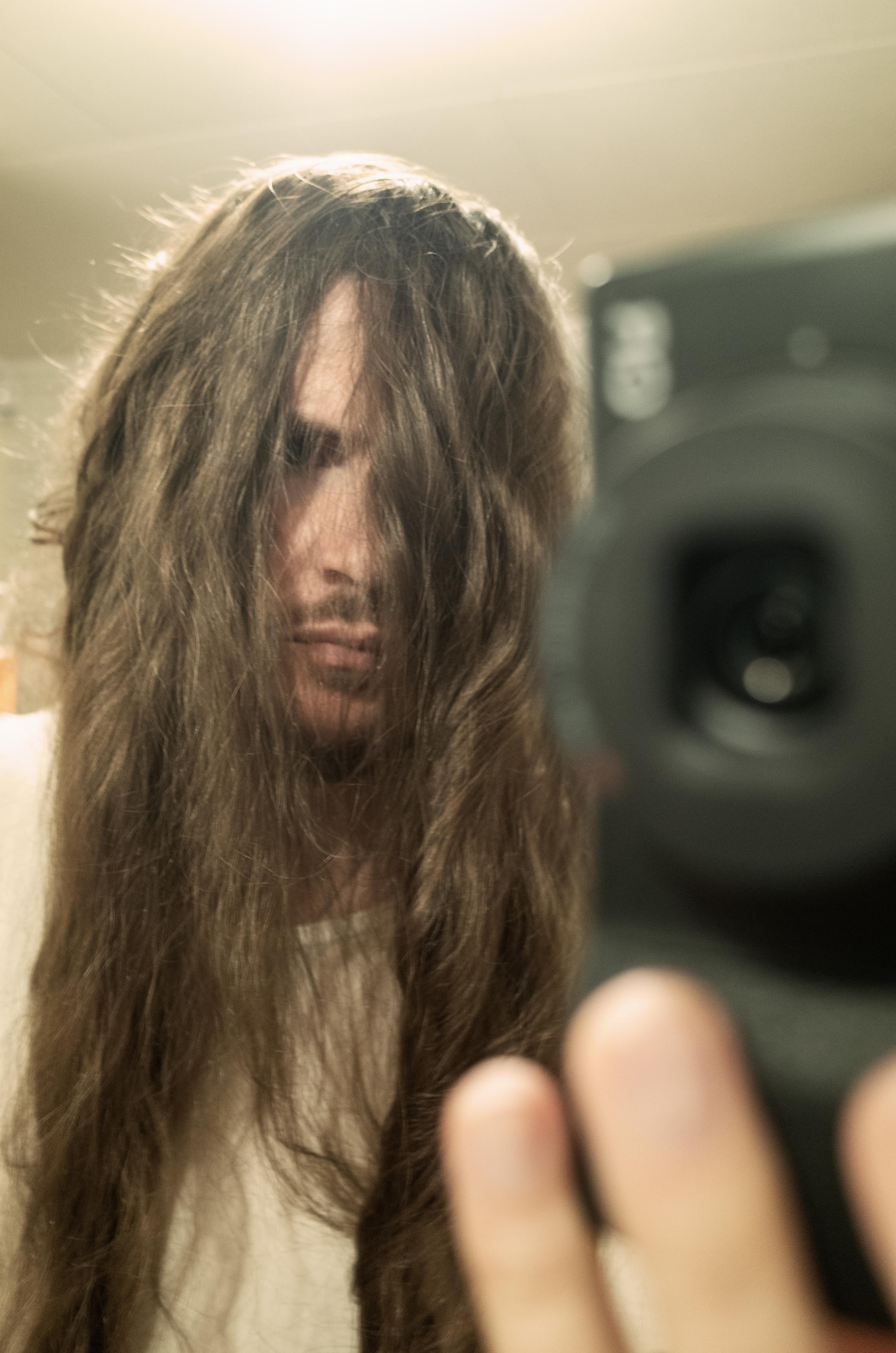 Mirror selfie with unkempt hair.