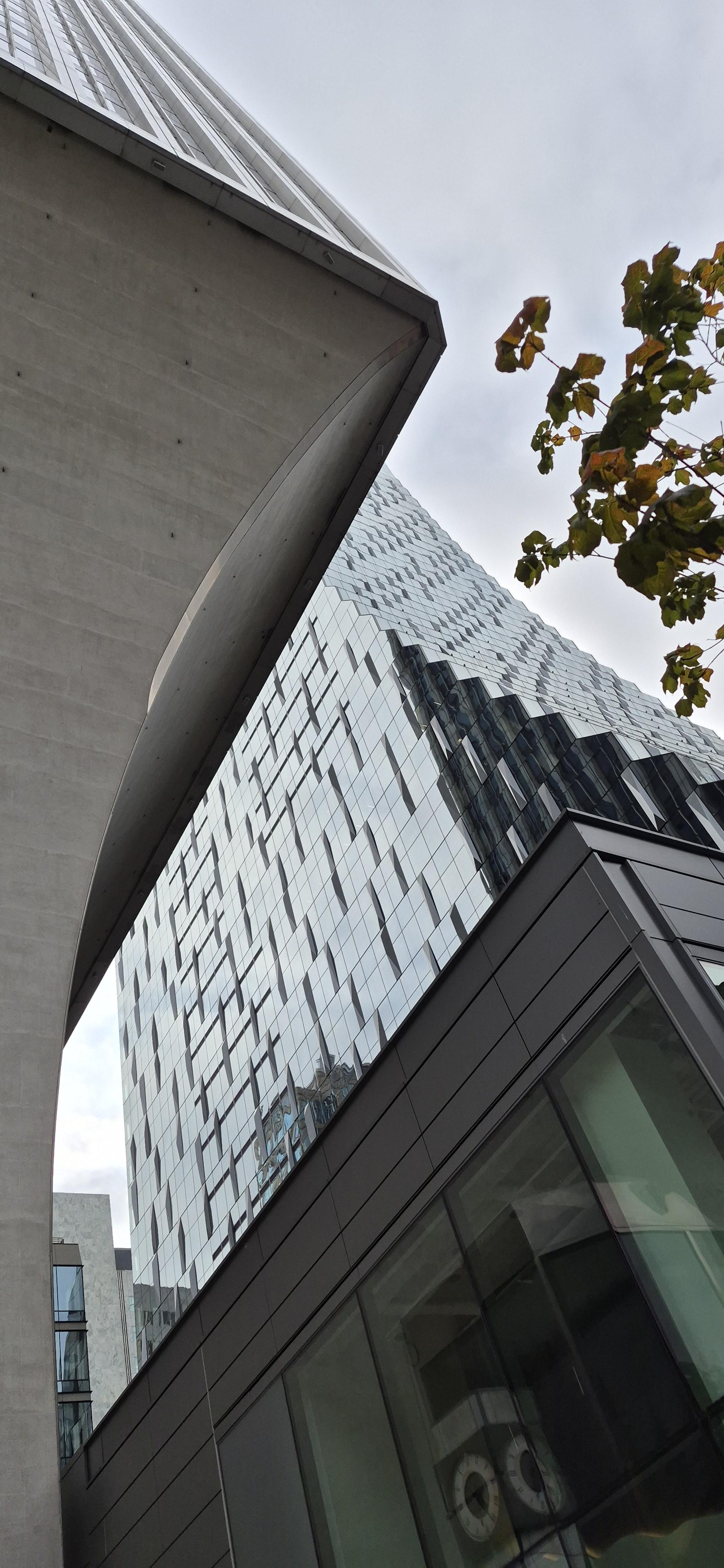 Seattle's curves glass facade Rainier Square tower as seen from under Seattle's curved concrete based Rainier Tower.