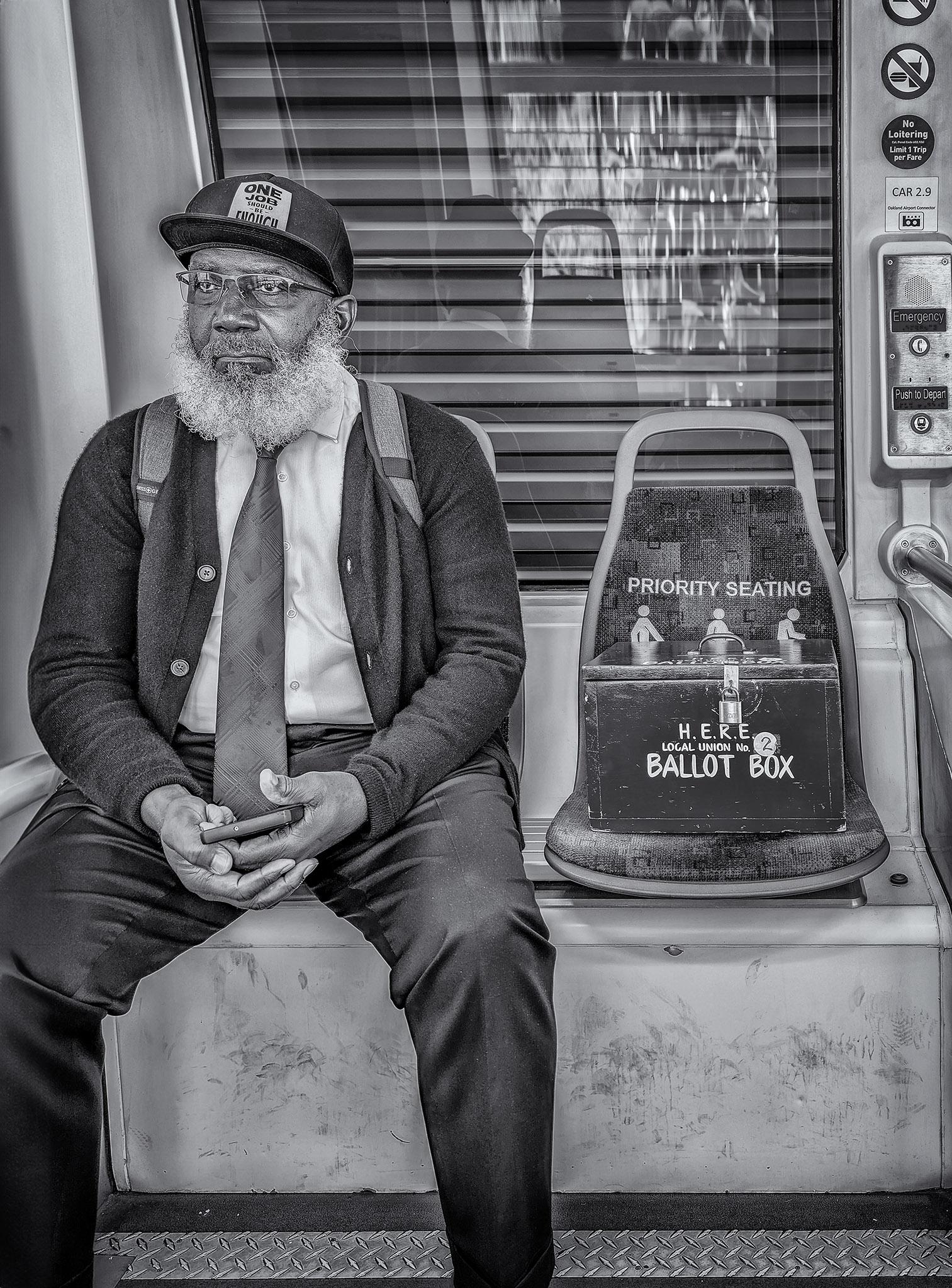 Union member carries a locked ballot box on a BART train in Oakland.