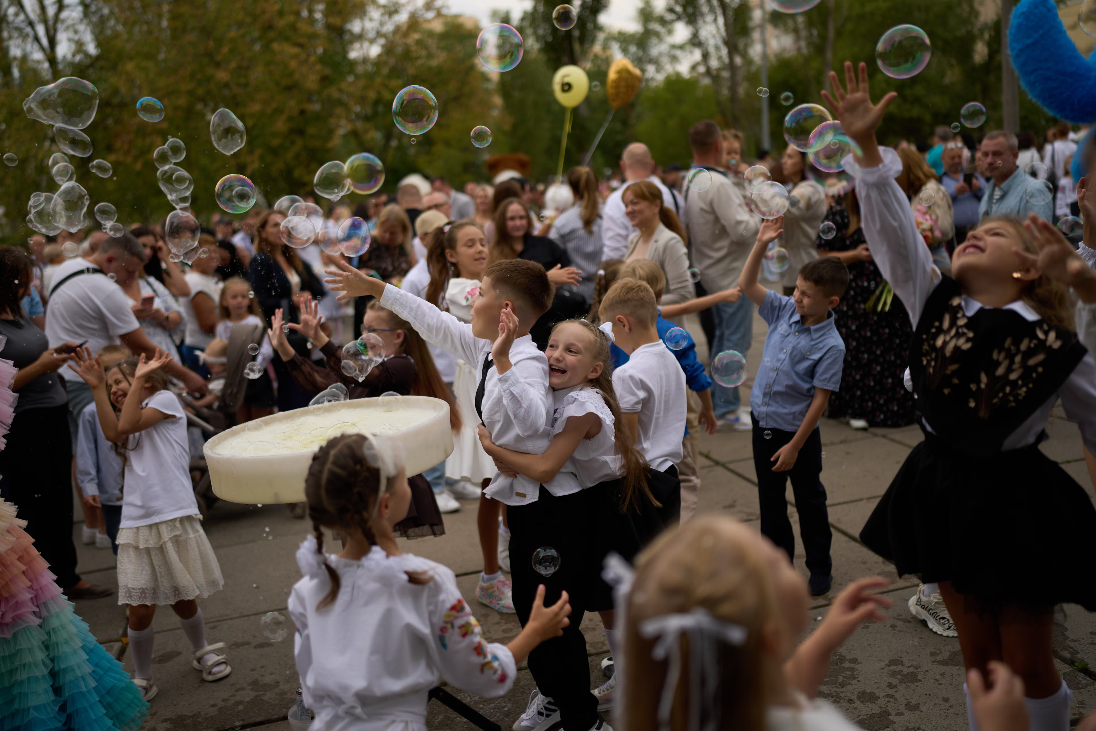 Children play with bubbles.