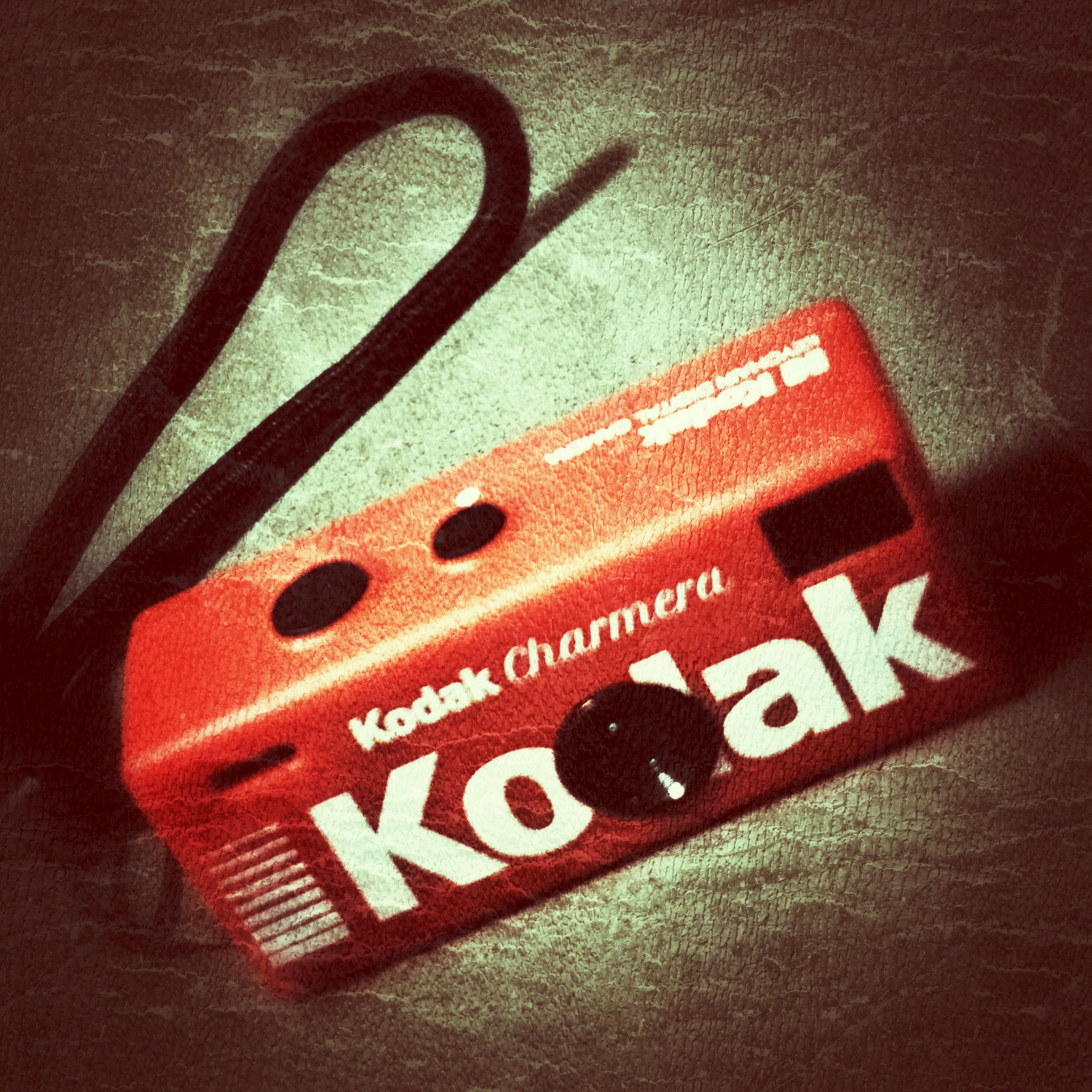 Picture of a small, red, Kodak Charmera. A tiny 1.6 MP keychain sized camera.