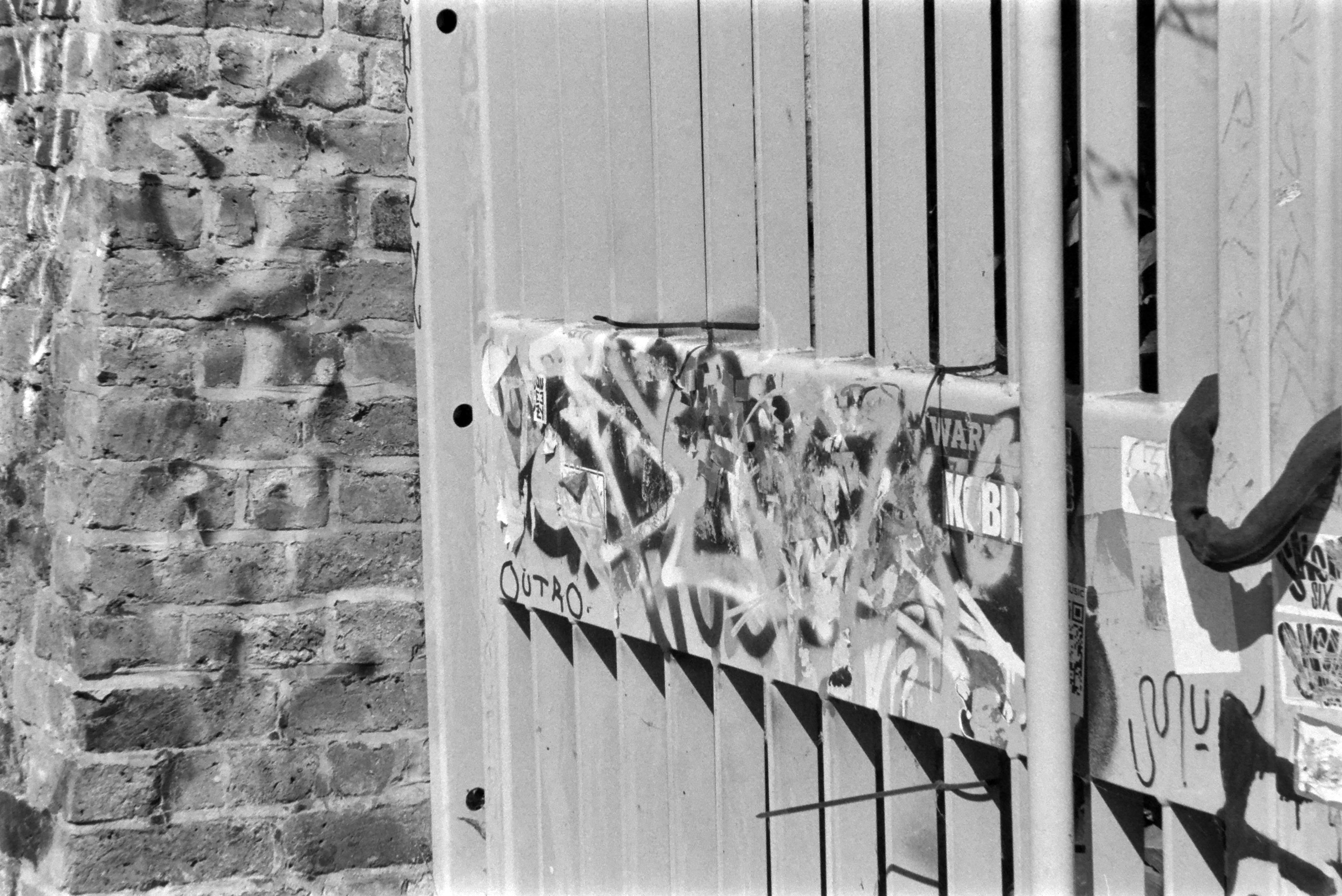 le détail d'un portail métallique couvert de graffitis
