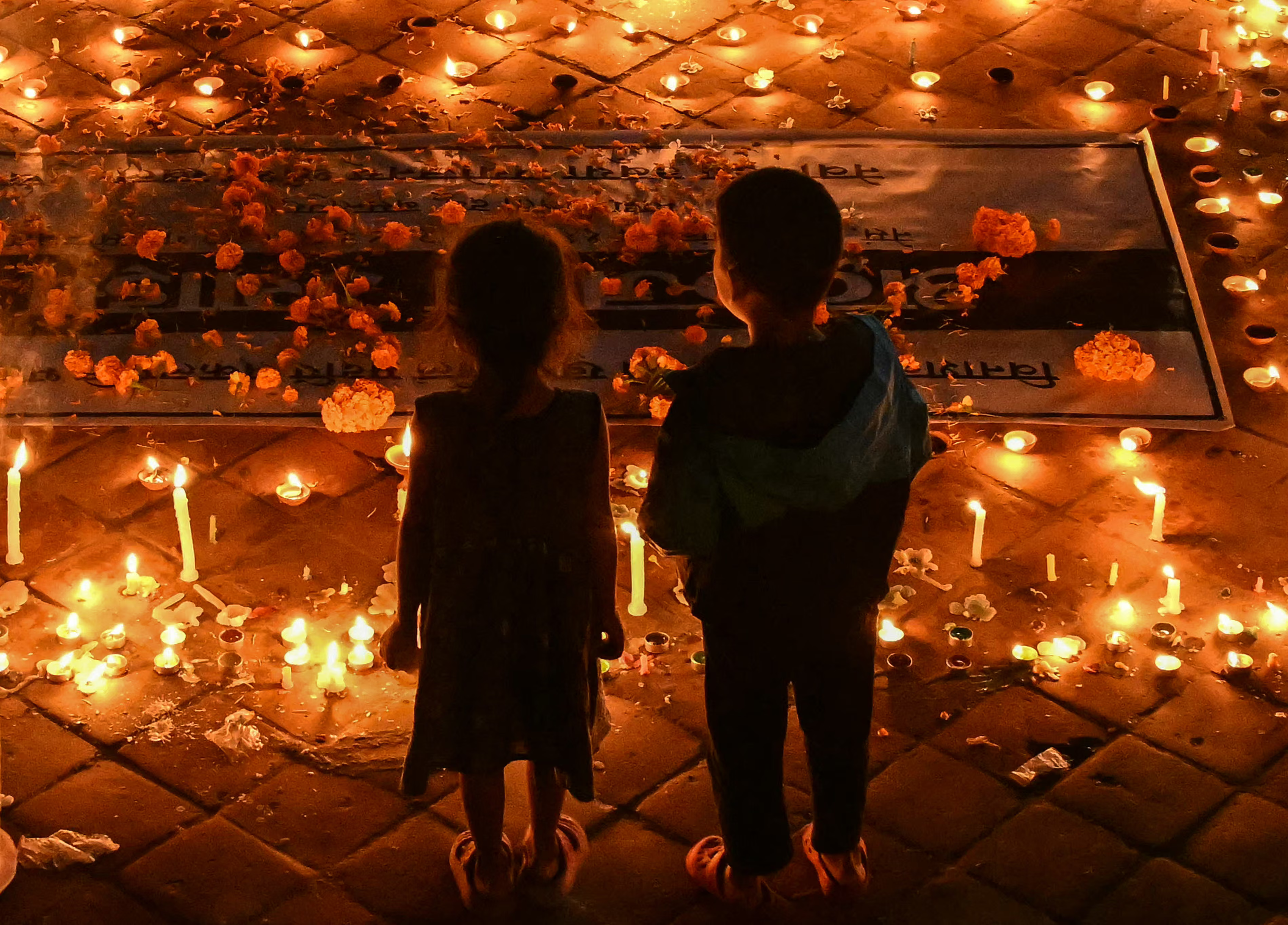 Children attend a gathering to observe a national day of mourning.
