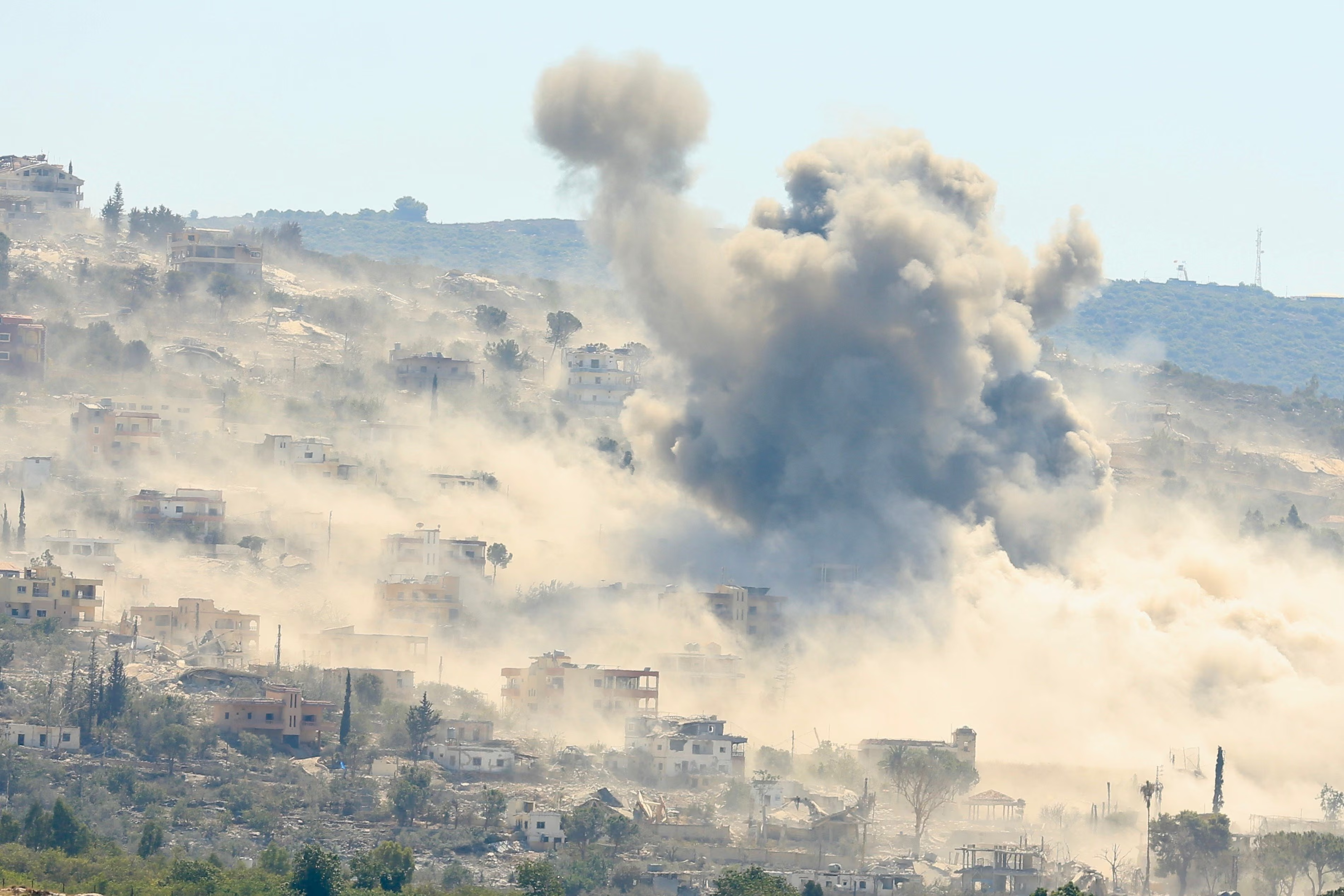 Smoke clouds a hillside after an Israeli airstrike on the town.