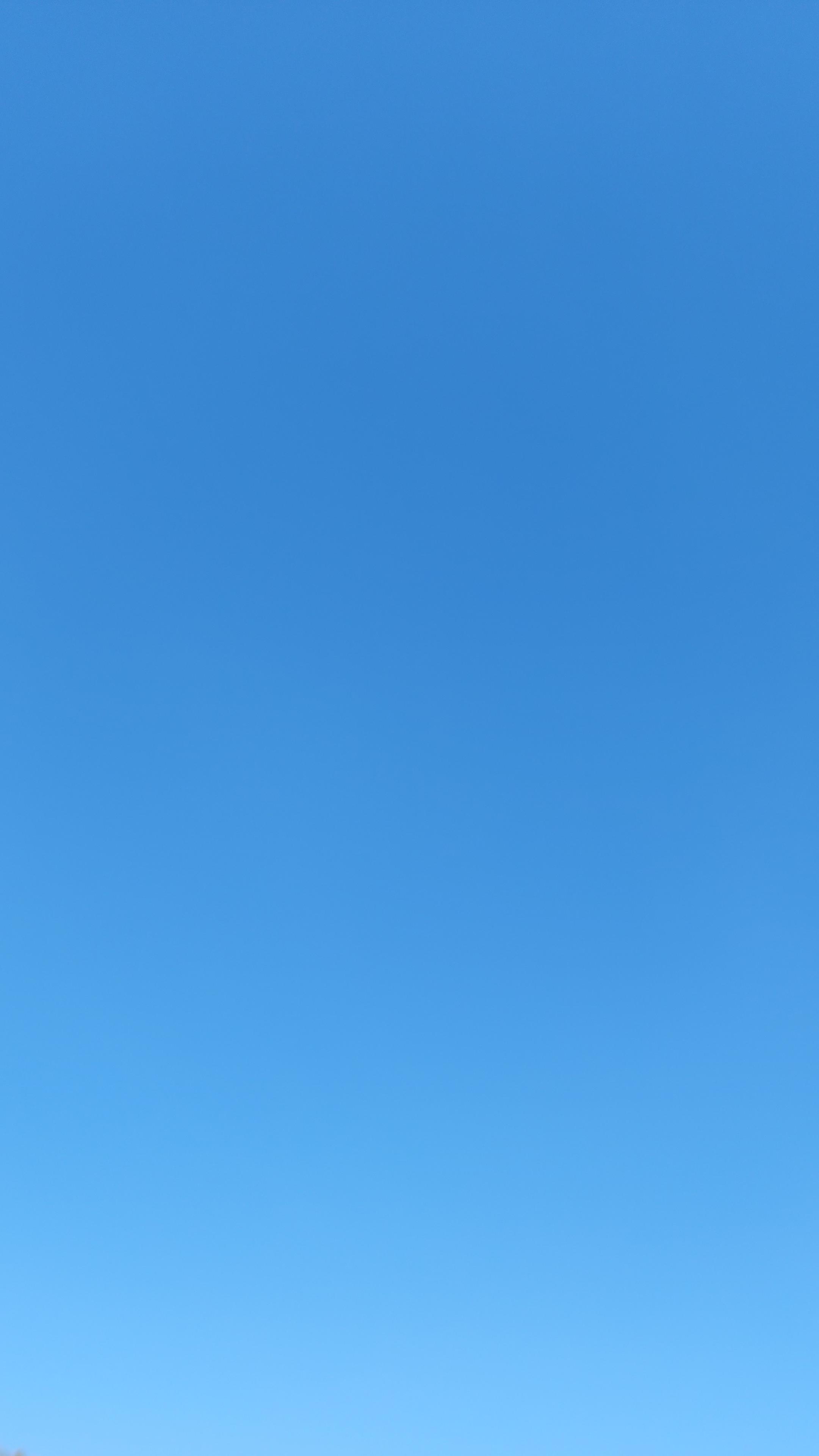 A clear, blue sky, with a subtle hue gradient, washing out at the bottom of the photo.