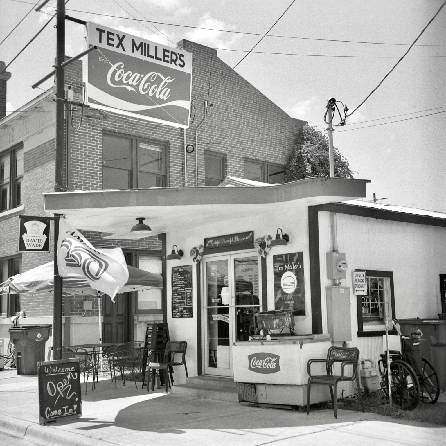 A black-and-white film photo. An exterior view of Tex Miller’s, a very popular classic restaurant in Cameron, Texas. Saturday, August 29, 2026.