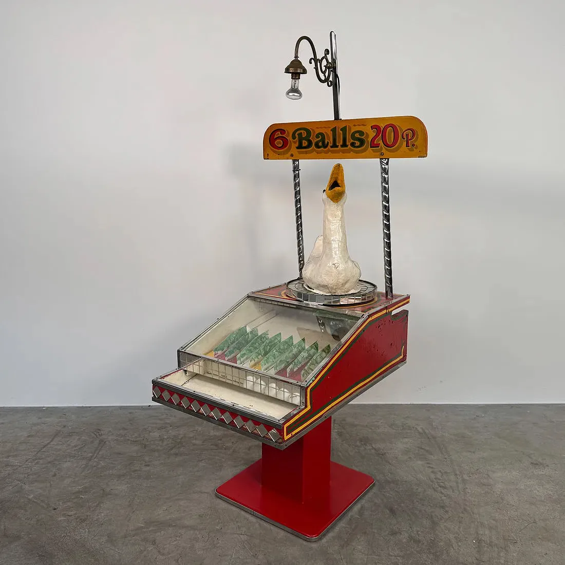 A carnival style rolling ball game featuring a goose that players threw balls into to score points. https://www.liveauctioneers.com/item/240446302_rare-british-1940s-1950s-goose-roll-a-ball-game-tilburg-north-brabant/
