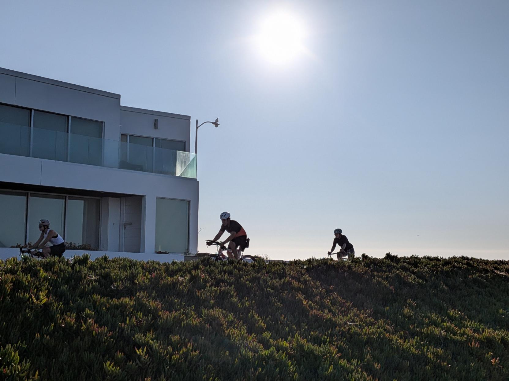 Bikes riding west cliff, backlit