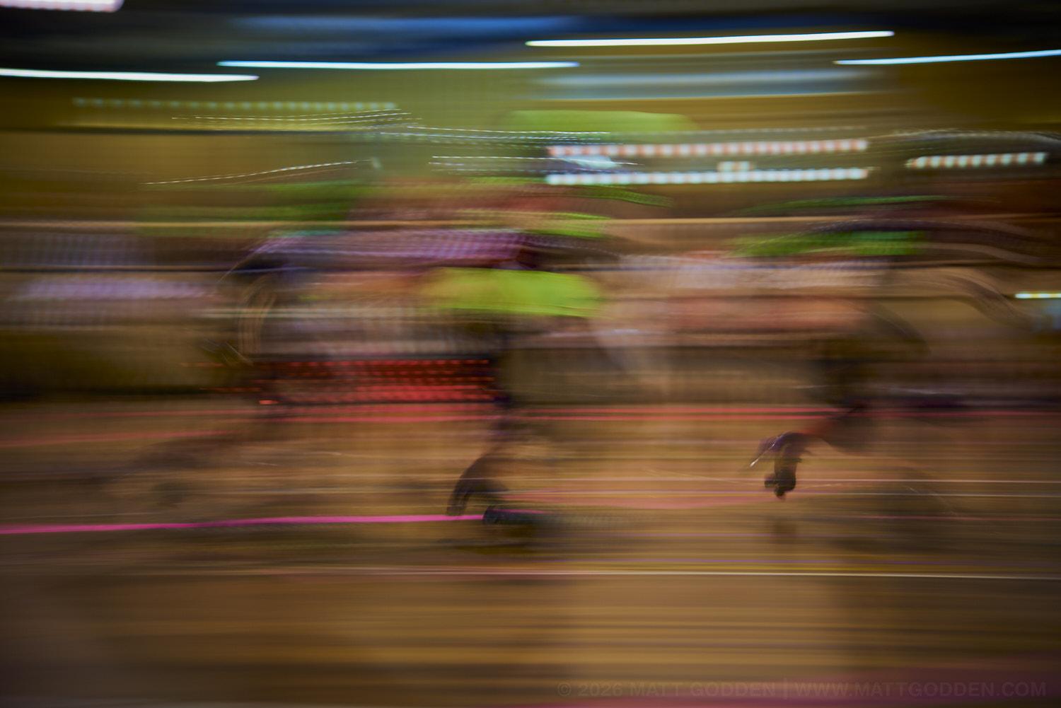 A long exposure image of roller derby competitors from the D'Viants (lime green), and the Screaming Assault Sirens (red). 2013/11/09