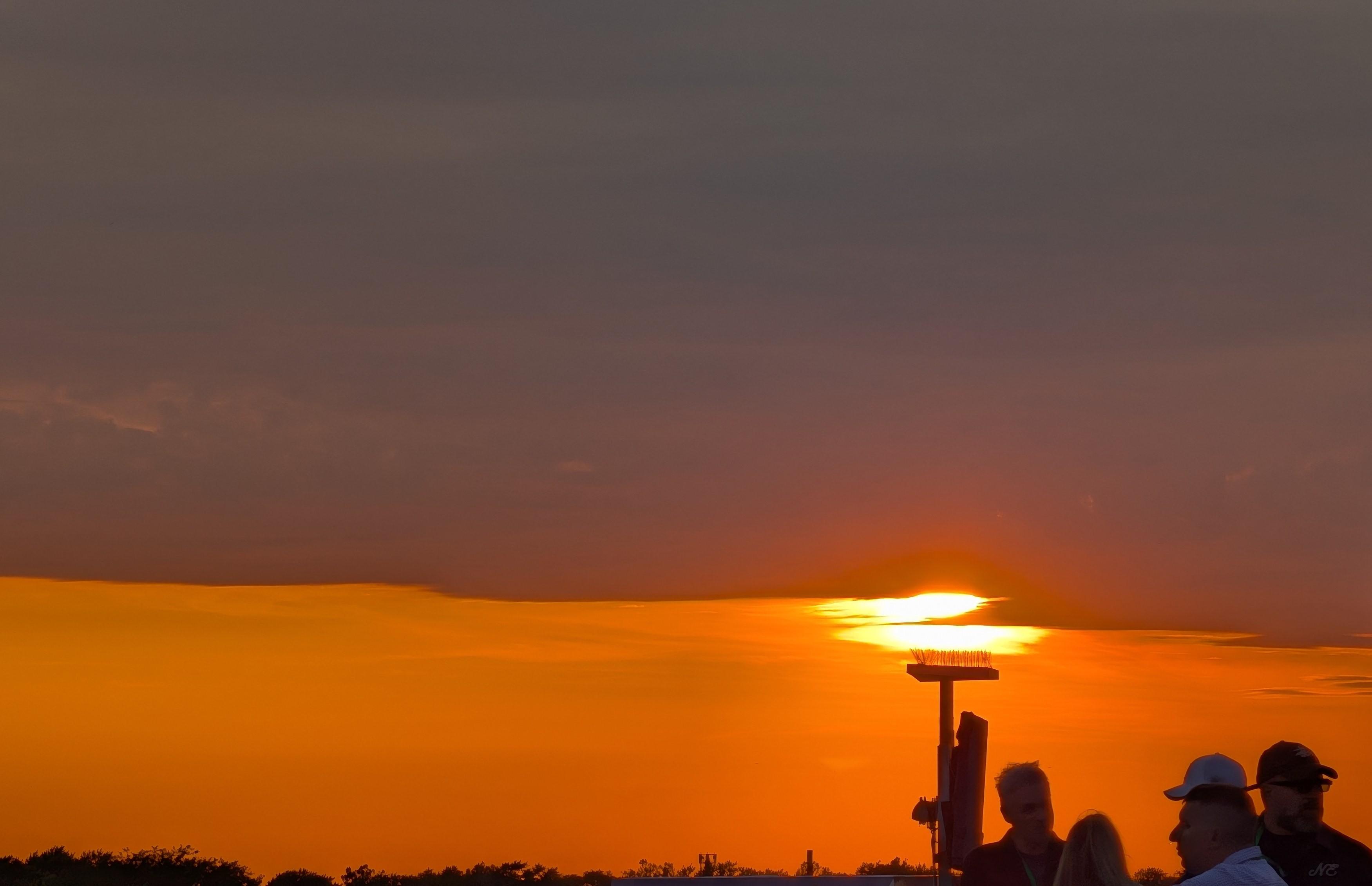 Baseball fans in front of a sunset