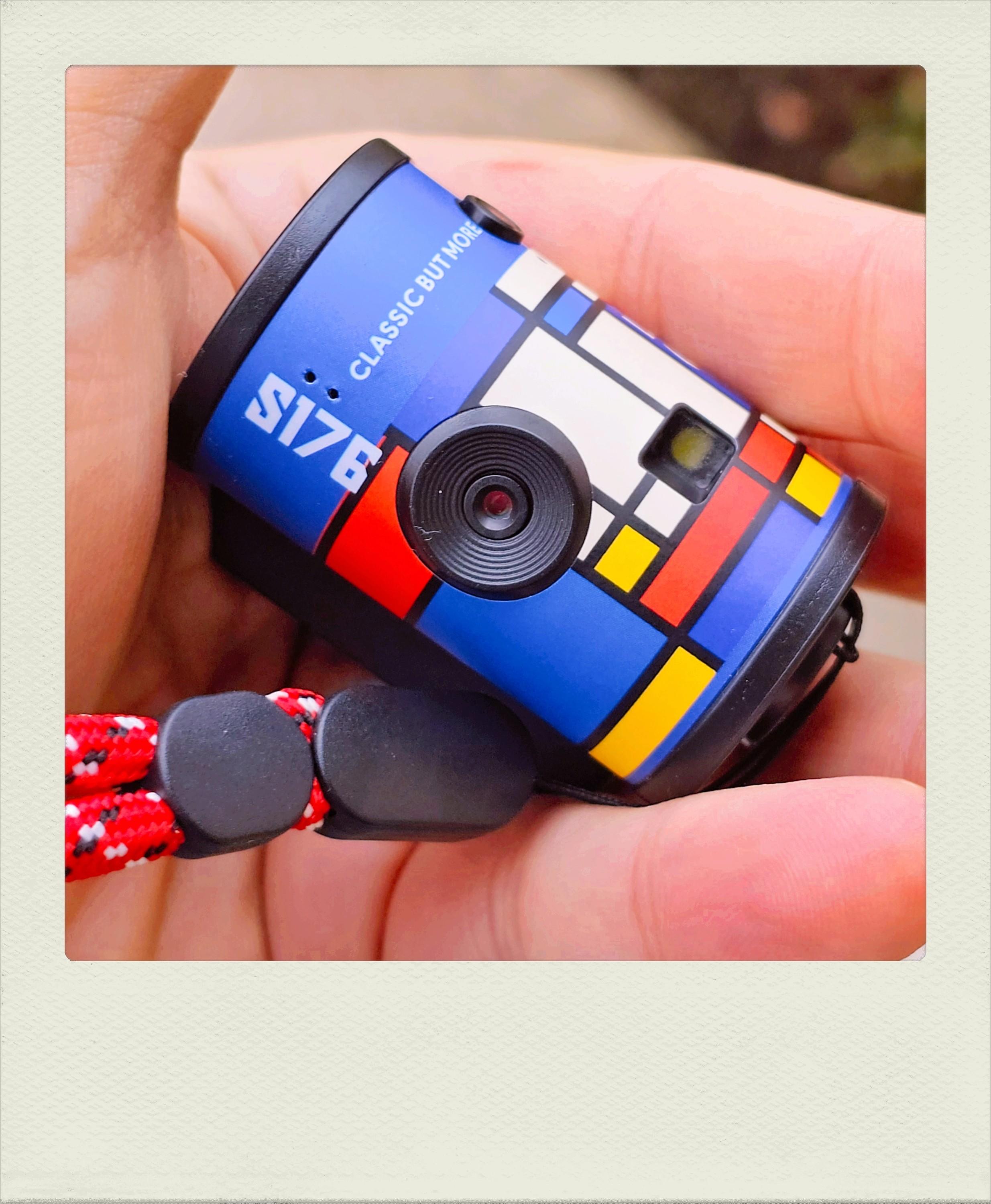 Toy digital camera shaped like a roll of film.