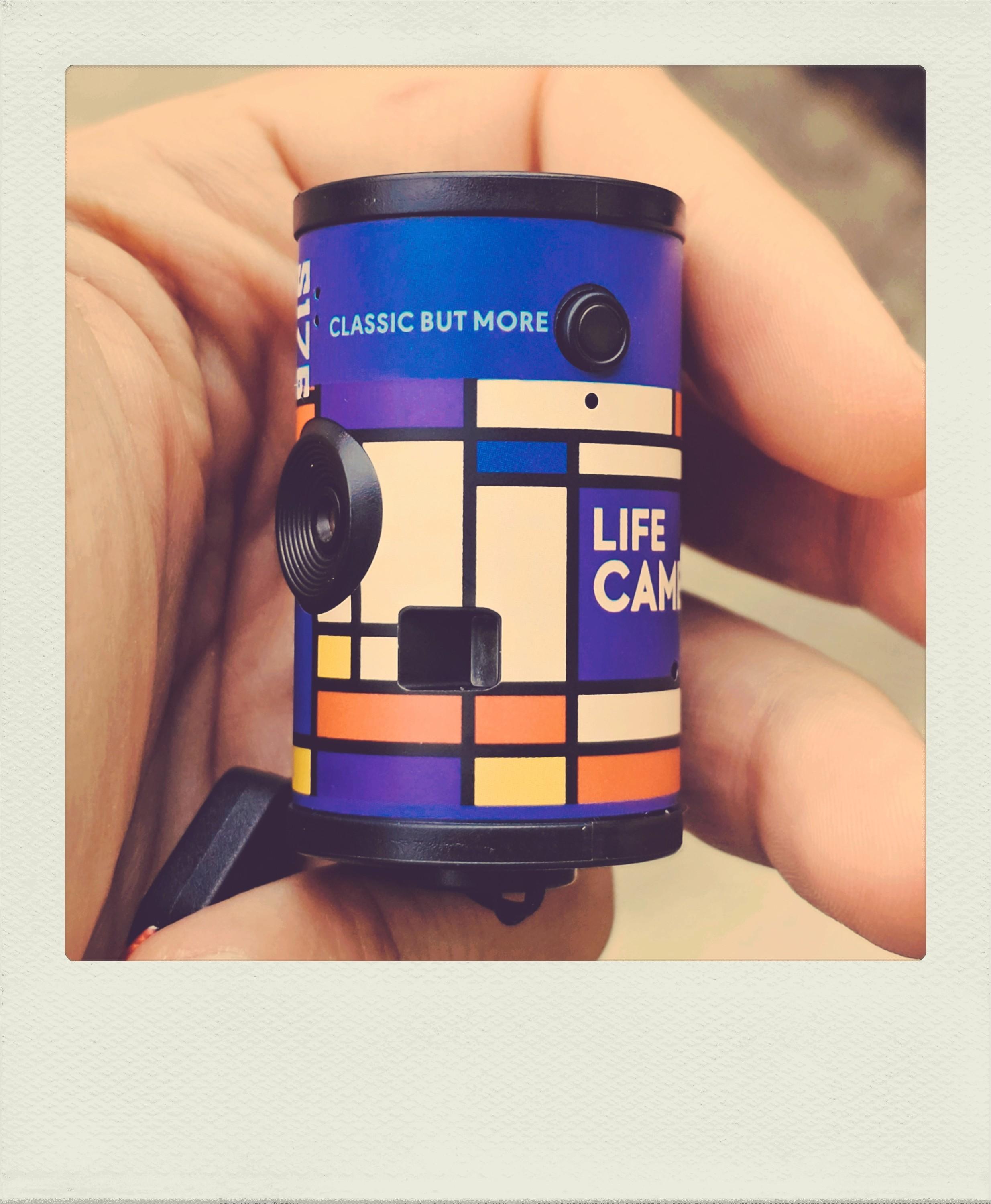Toy digital camera shaped like a roll of film.
