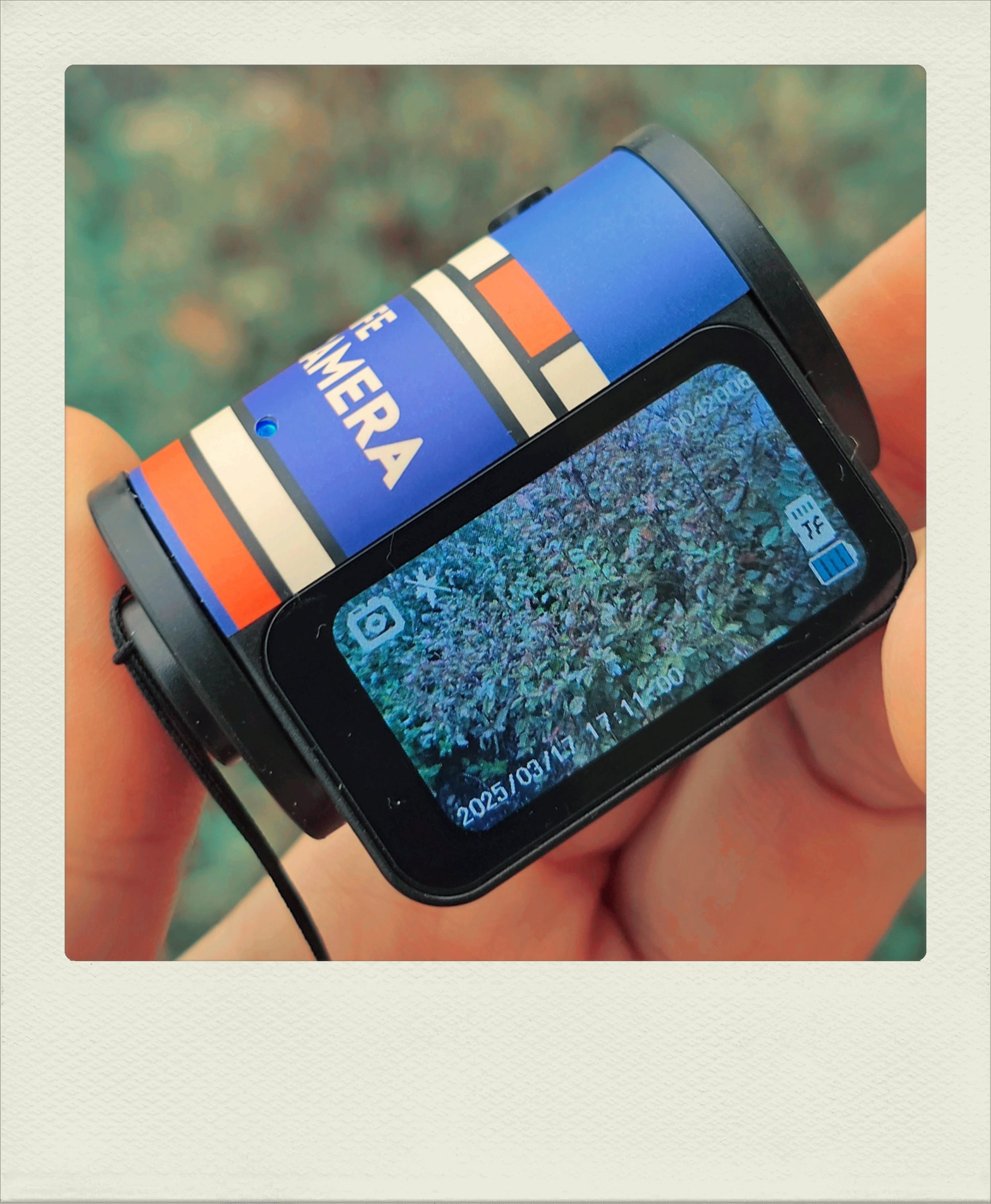 Toy digital camera shaped like a roll of film.