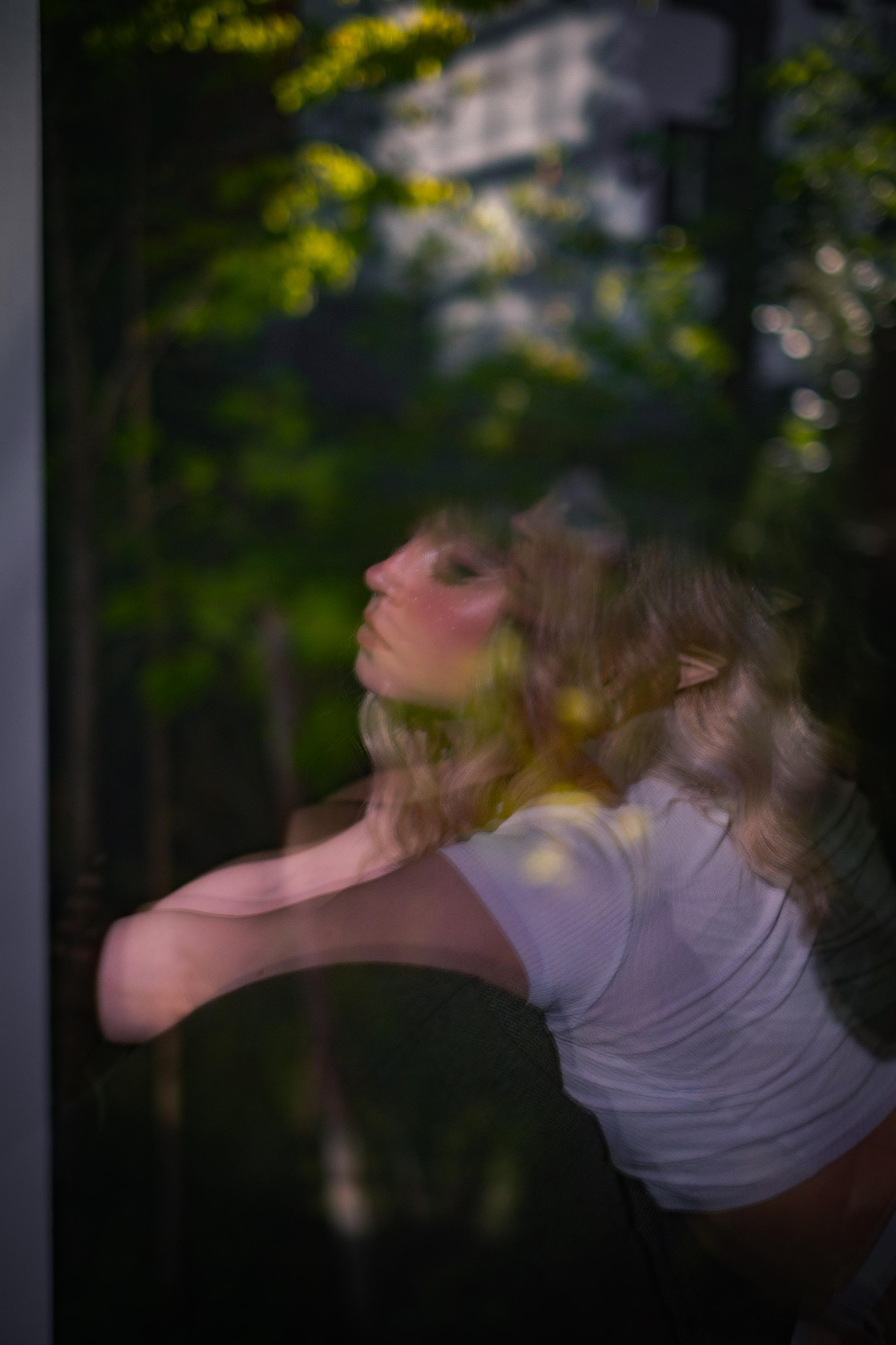 Reflection of an elf girl and a forest on the window