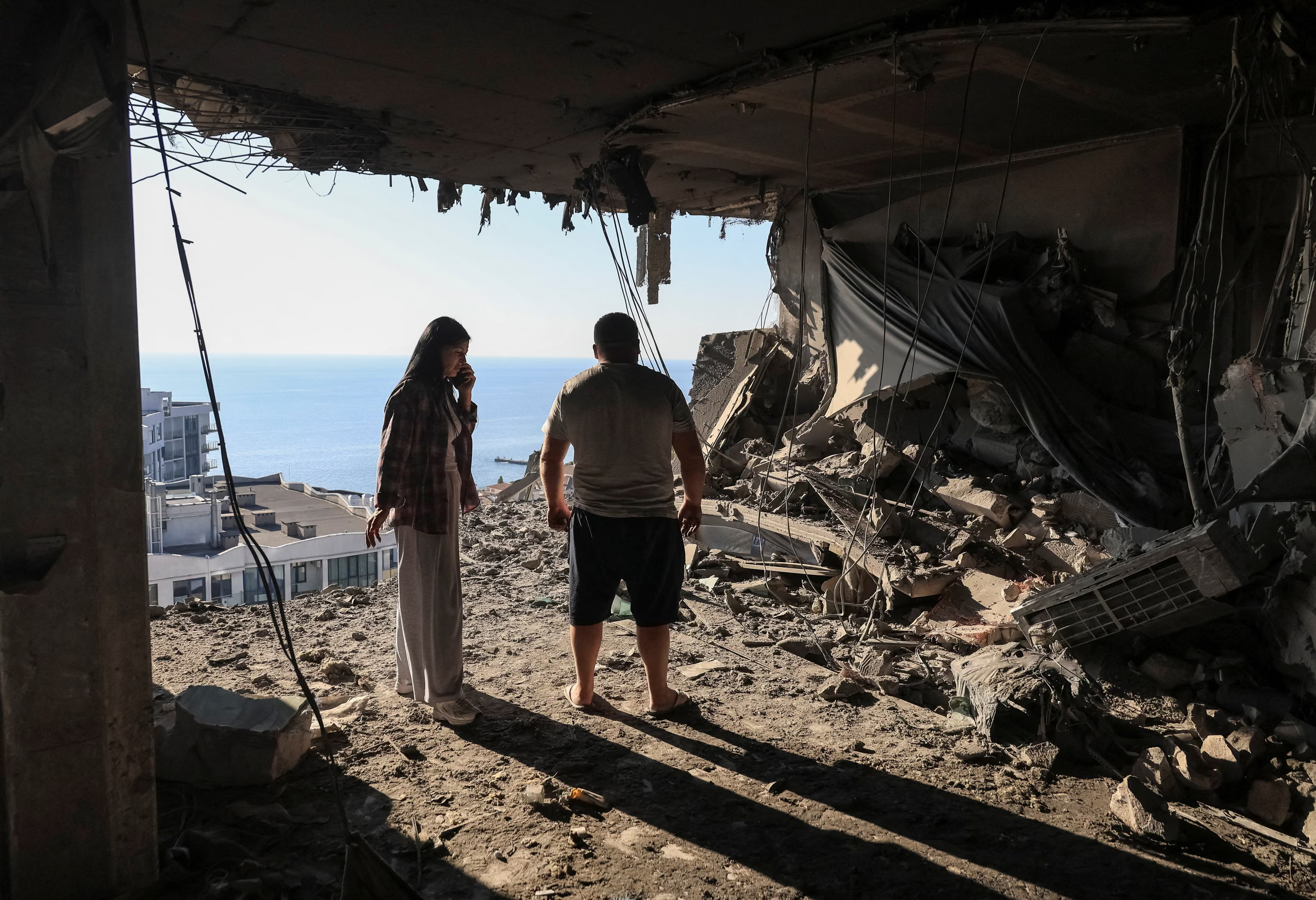 A couple inspected their destroyed flat.