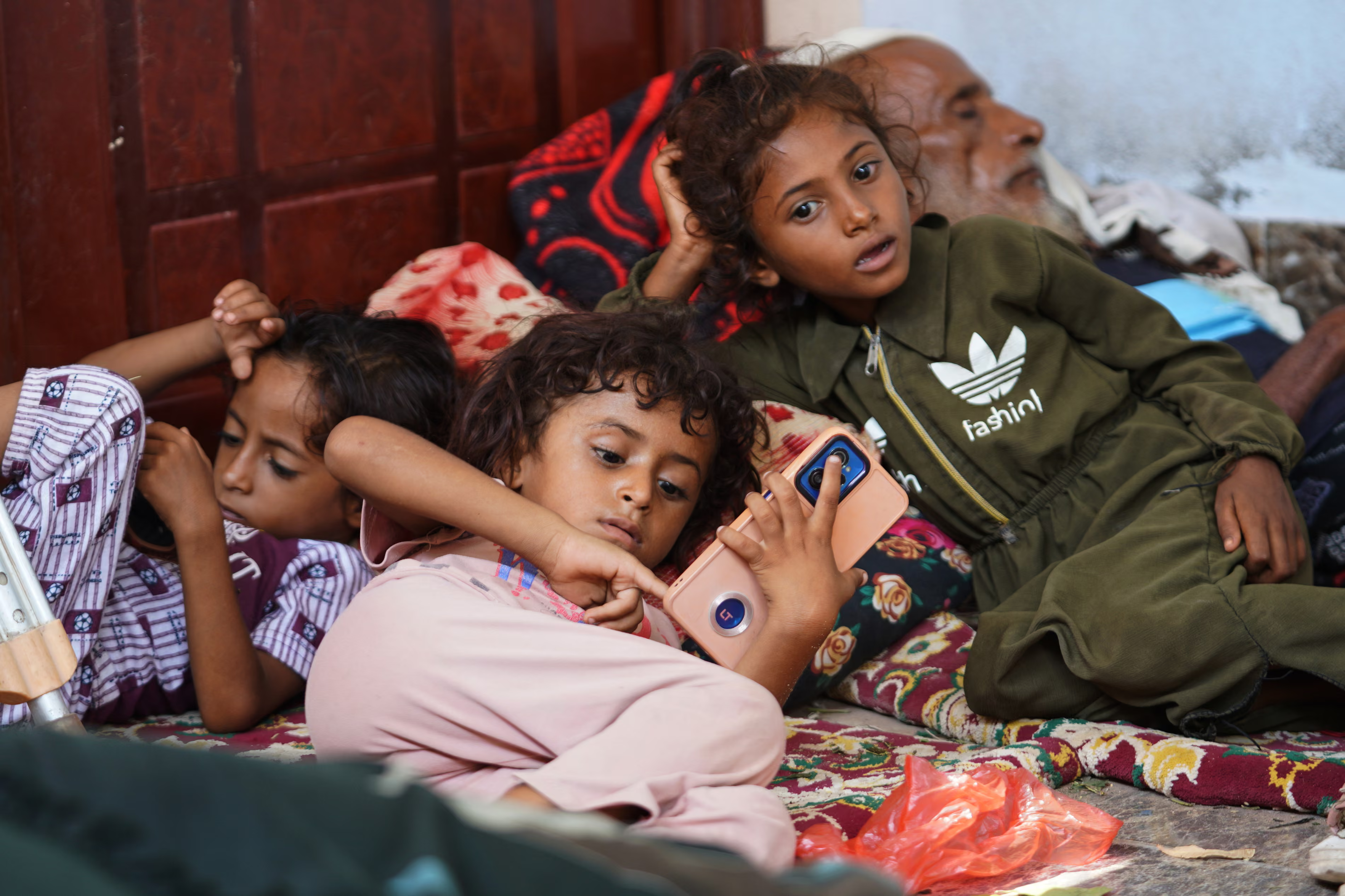 Displaced Yemeni children rest at a temporary shelter.