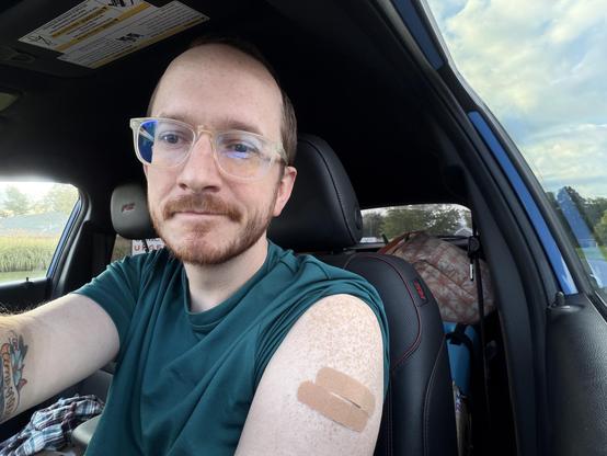Selfie in the car showing off my Band-Aids