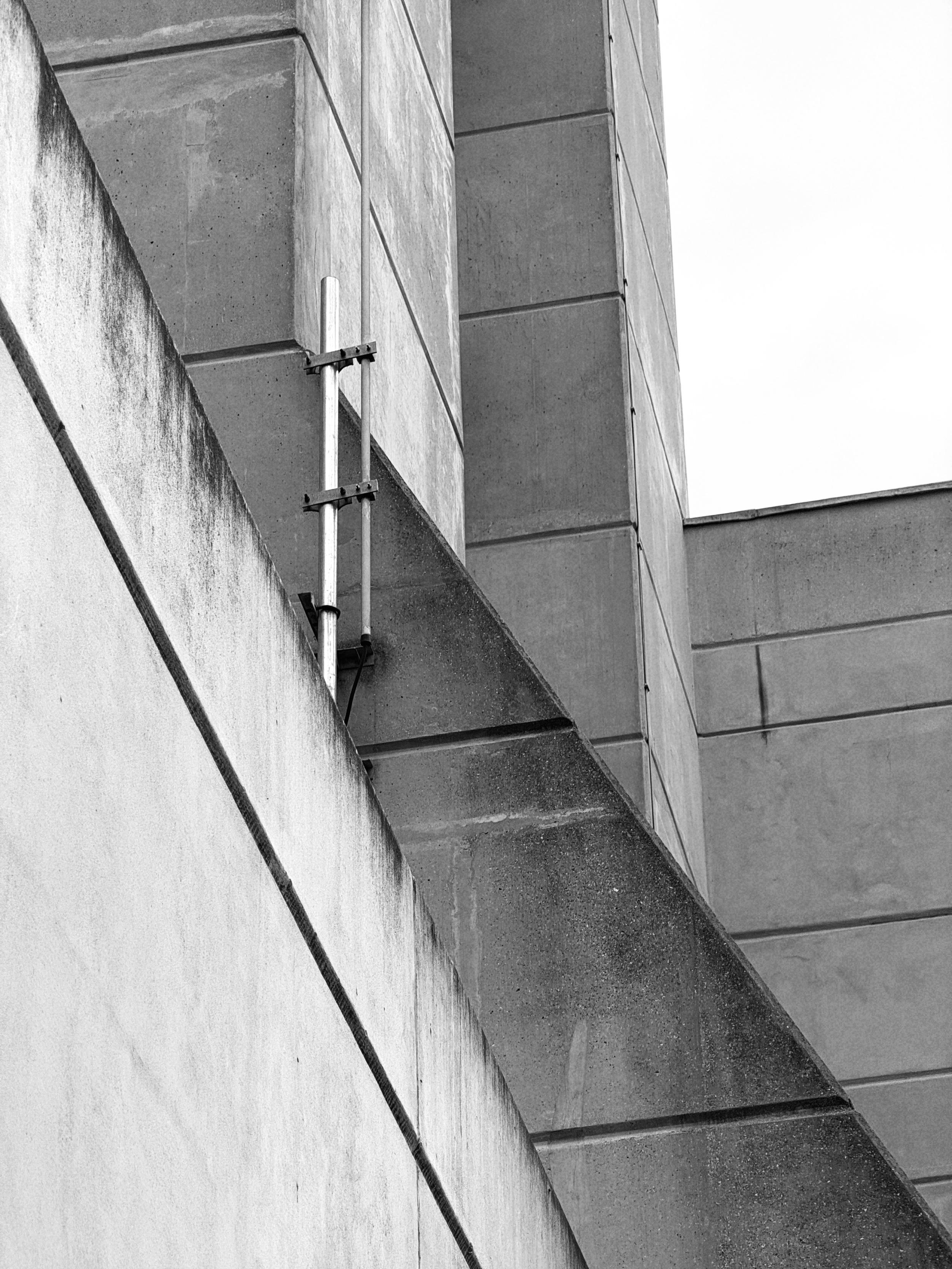 Black and white photo of the Brunswick Centre’s concrete architecture — a diagonal line against vertical walls