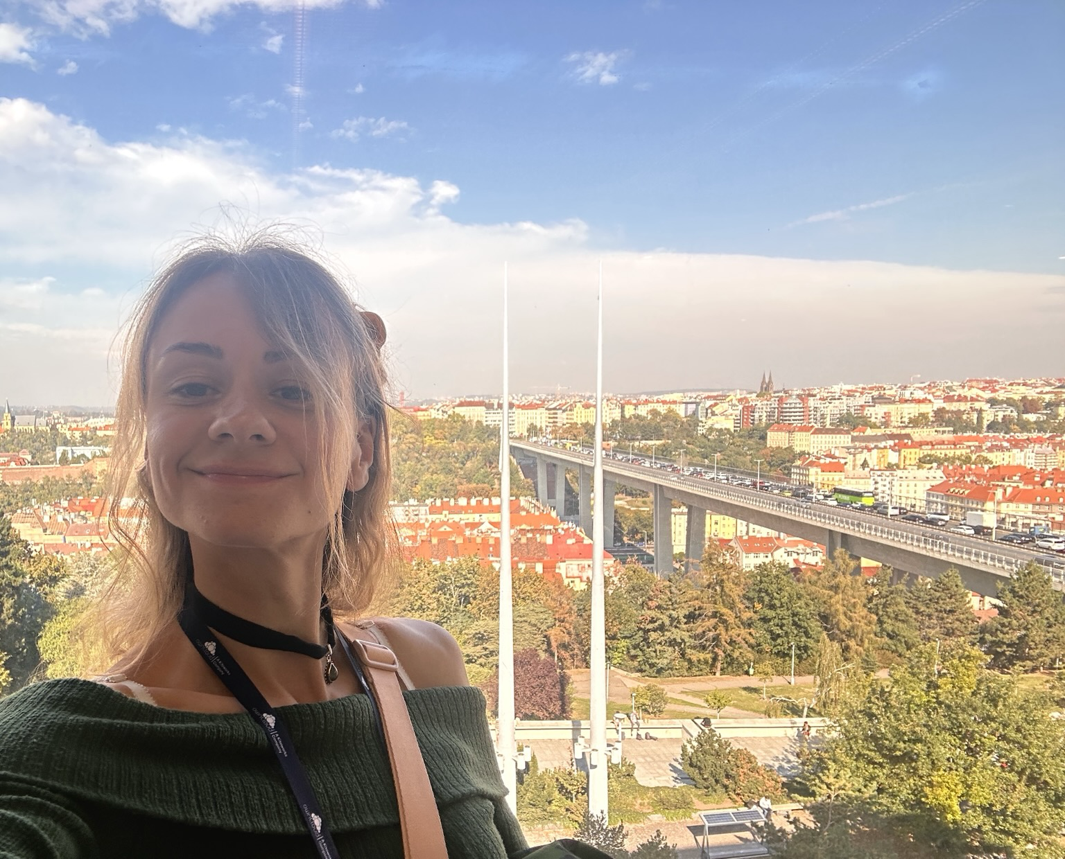 A selfie of Miranda in front of a Prague cityscape