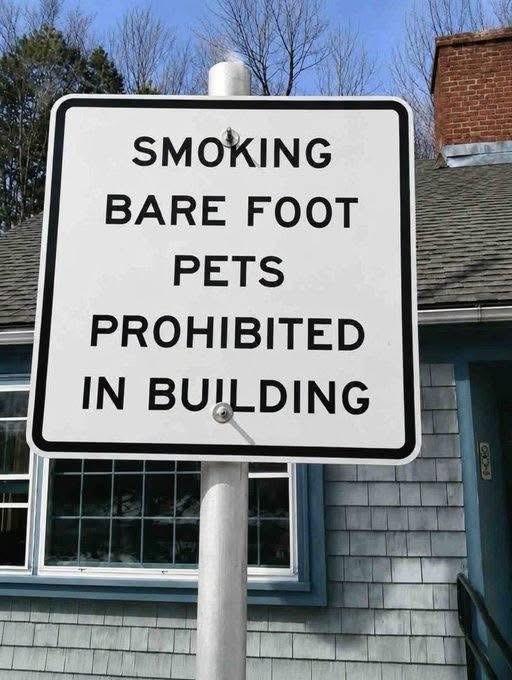 Photo of a white sign with black lettering. 

It reads:

SMOKING BARE FOOT PETS PROHIBITED IN BUILDING