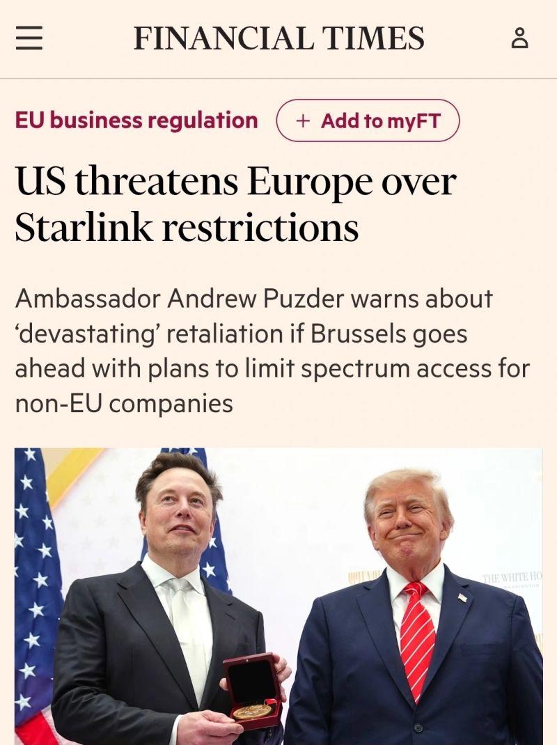 Screenshot of a Financial Times article headlined “US threatens Europe over Starlink restrictions”. The subheading reads: “Ambassador Andrew Puzder warns about ‘devastating’ retaliation if Brussels goes ahead with plans to limit spectrum access for non-EU companies.” Below the headline is a photograph of Elon Musk, holding a medal in an open presentation case, standing beside Donald Trump. American flags are visible in the background.