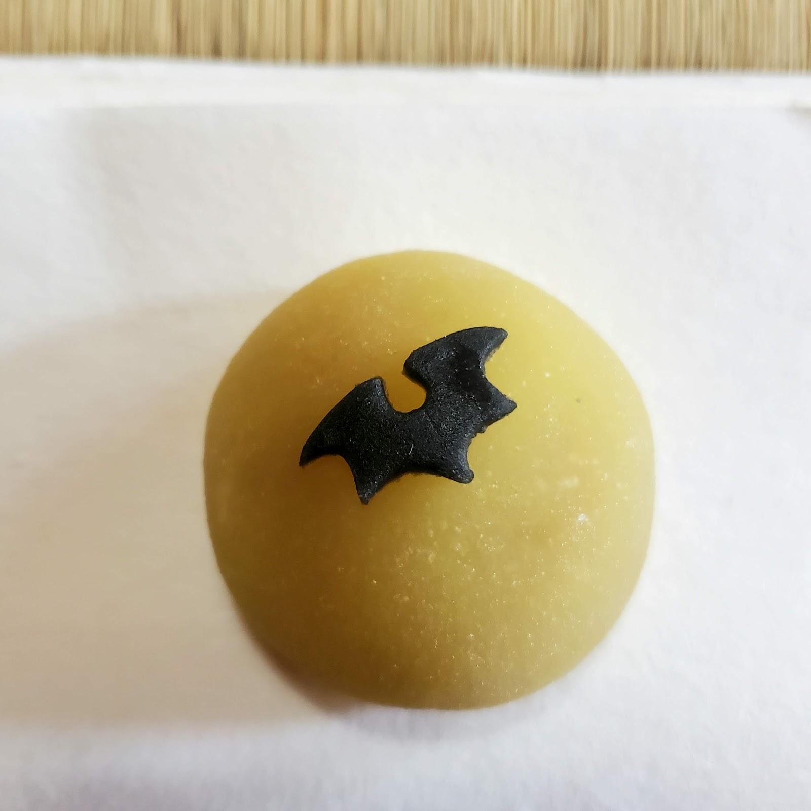 Sweet depicting a bat flying over a full moon.