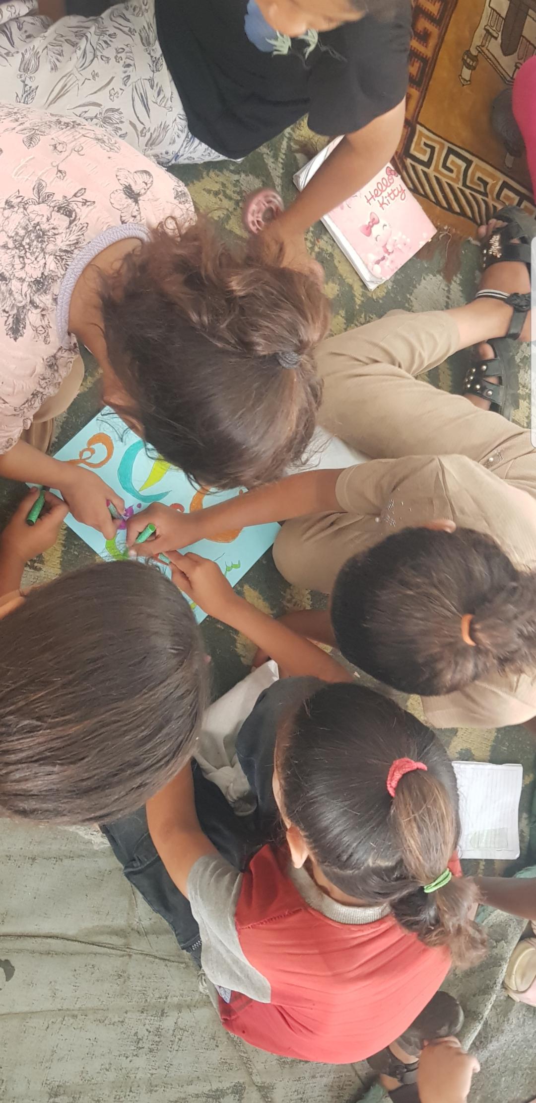 Our innocent children in Gaza coloring together in a shelter to ease the signs and pain of war; please support us and stand by us to continue.